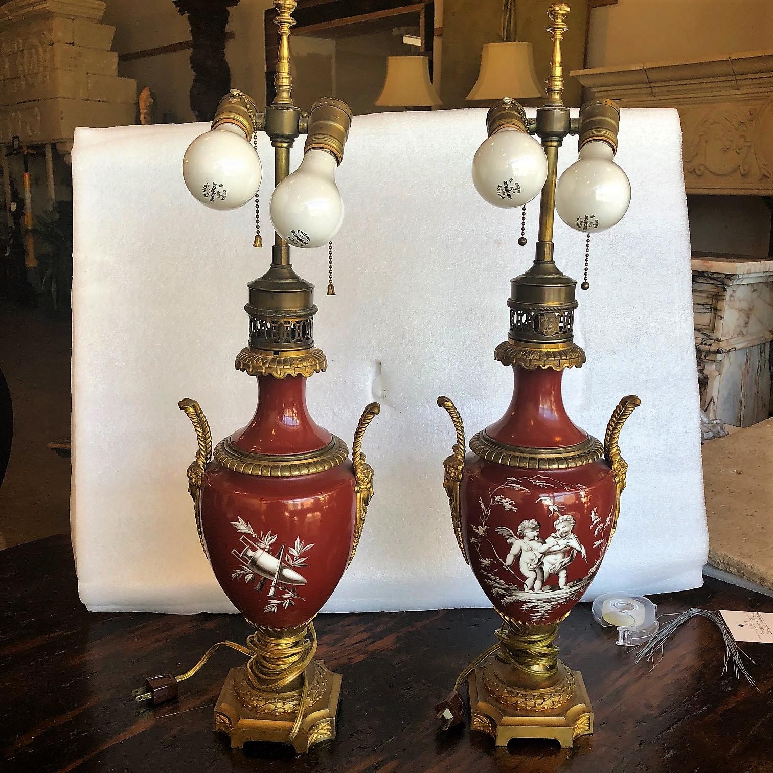 Here we have a pair of French lamps made of beautifully carved bronze and hand-painted porcelain. 

circa 1900

Origin: France

Measurements:
7