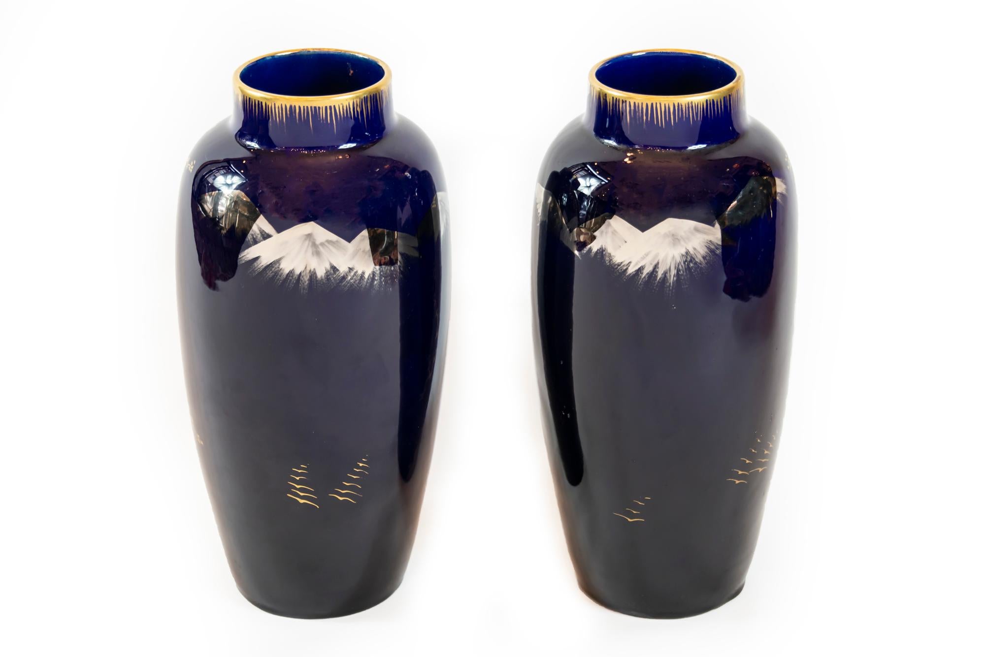 Pair of French cobalt blue vases decorated with birds in gold. Probably created by Gustave Asch and made by Sainte Radegonde.