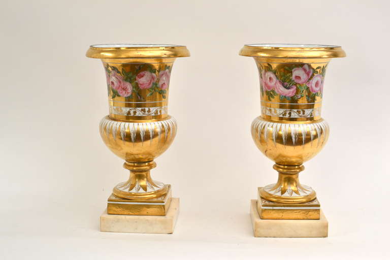 A pair of French porcelain gold-ground and flower painted vases on white marble bases, circa 1825.
Painted signature underneath. Baigol F a Limoge.