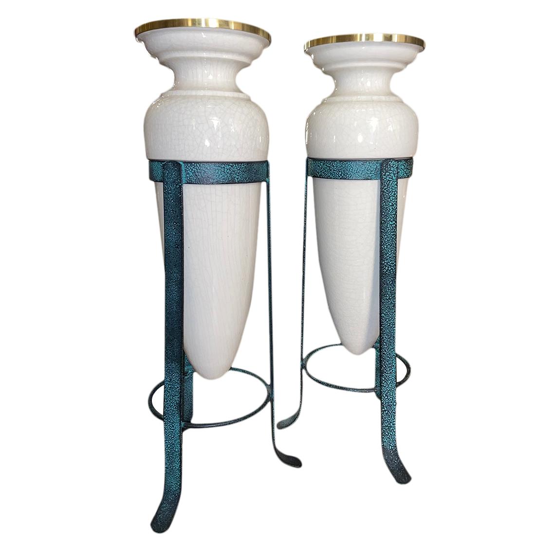Pair of circa 1950s French porcelain lamps with iron bases, one single interior light each.

Measurements:
Height 23.25