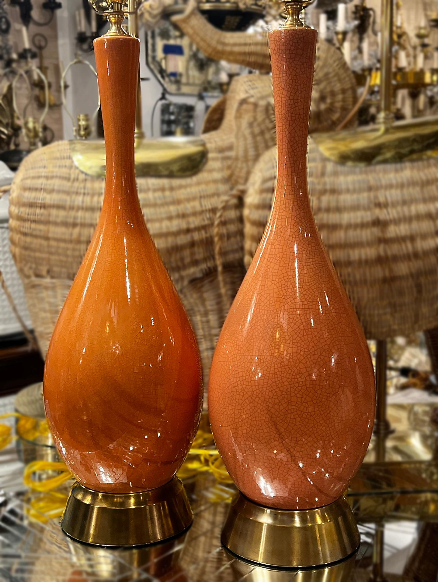 Pair of circa 1950's salmon-colored glazed porcelain lamps.

Measurements:
Height of body: 22
