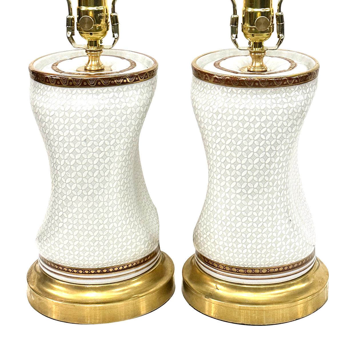 Pair of circa 1920's French porcelain lamps with gilt details.

Measurements:
Height of body: 12