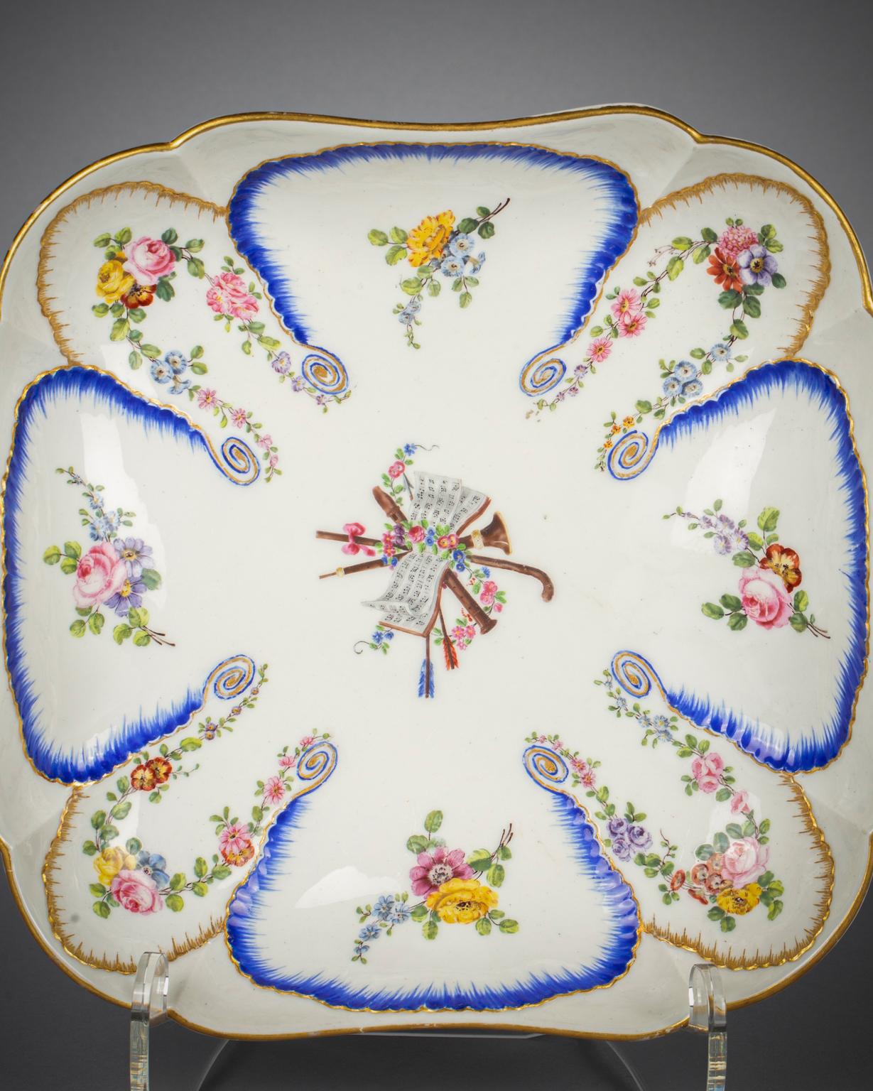 With fluted decoration in the Feuille de choux (cabbage leaf) pattern. Each leaf meticulously painted with a floral bouquet, the center painted with a musical score, instrument and trophy. Painter: Claude Couturier.