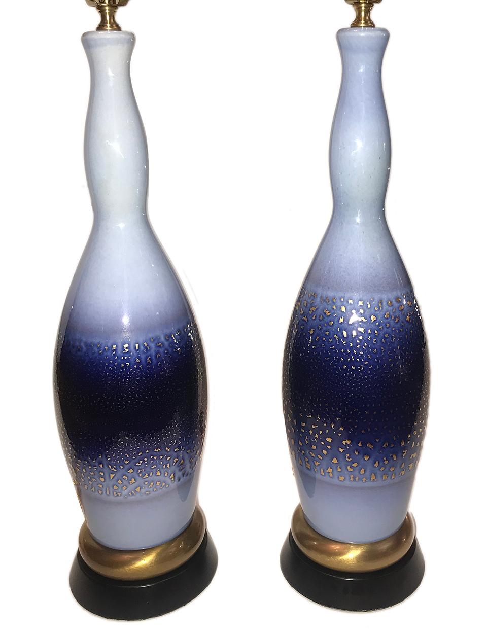 Pair of late 1940s French blue porcelain lamps with gilt details.

Measurements:
Height of body: 21.5