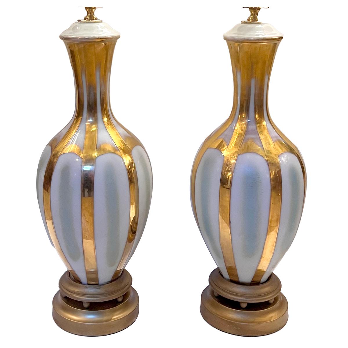 A pair of French circa 1940's gilt and white porcelain table lamps.

Measurements:
Height of body: 21