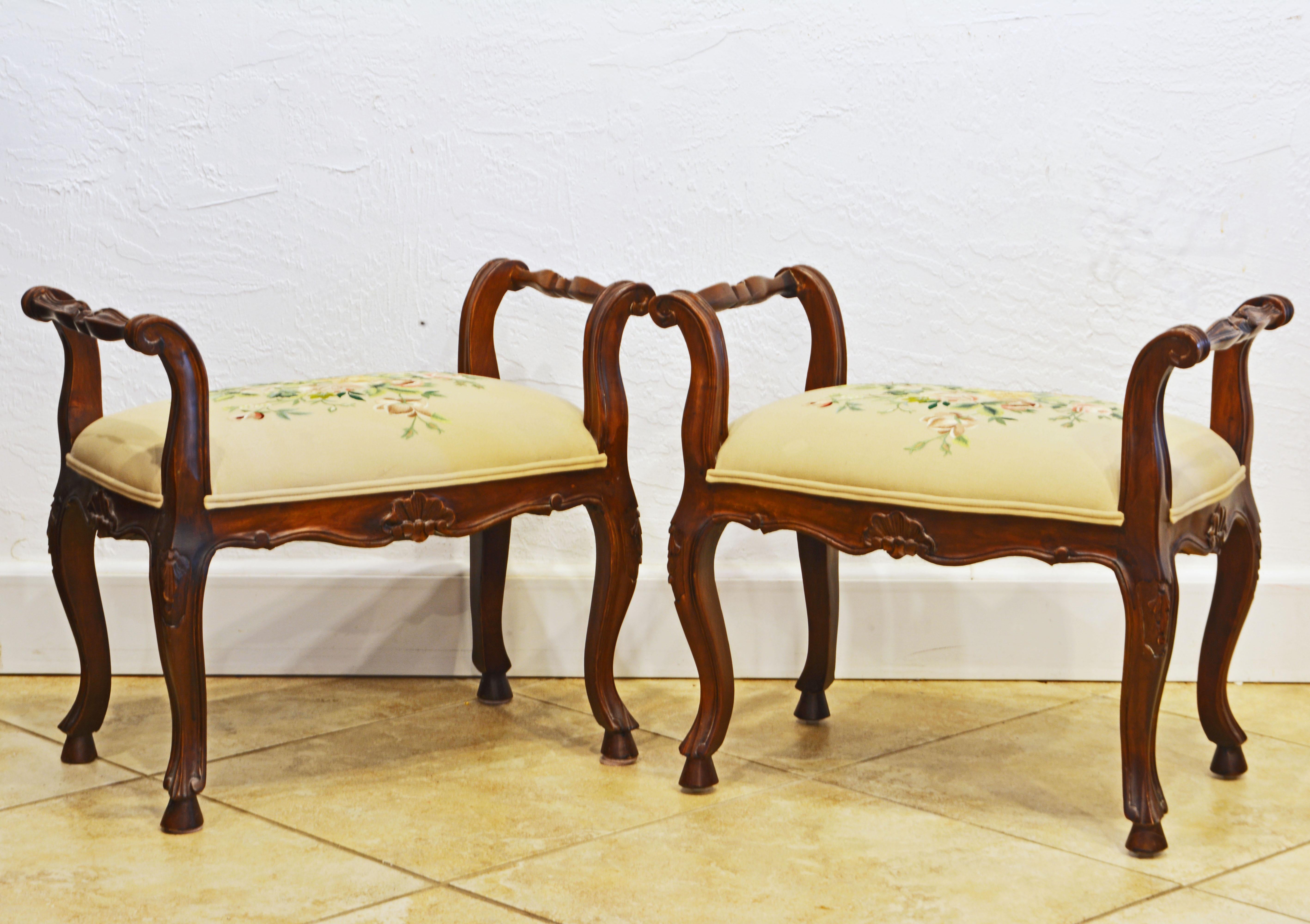 This fetching pair of French Provincial carved walnut benches, dating to the mid 20th century feature attractively curved frames and aprons. The seats are tastefully upholstered and covered with silk embroidered fabric.