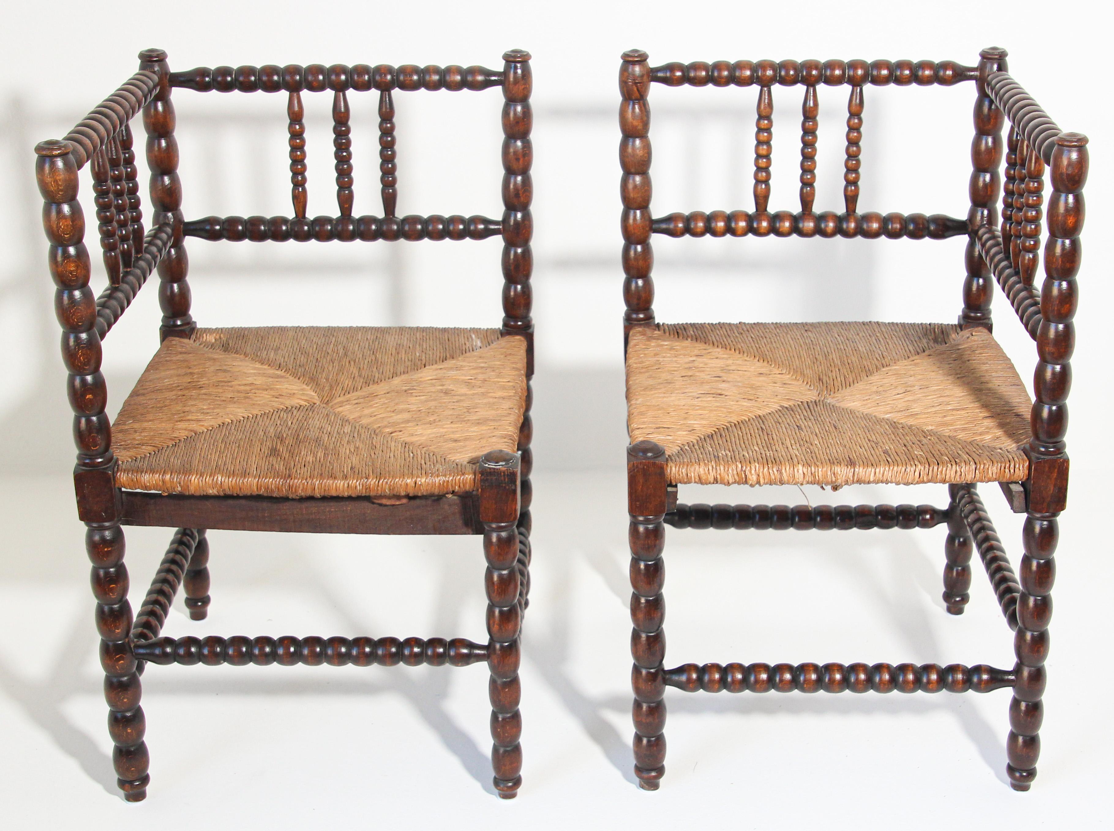 Pair of French rush-seat corner chairs, Coin du Feu.
19th Century French Provincial-style carved fruitwood armchairs with open backs and rush seats.
Pair of antique sturdy useable chair, wood stick and ball craftsmanship corner chair with original