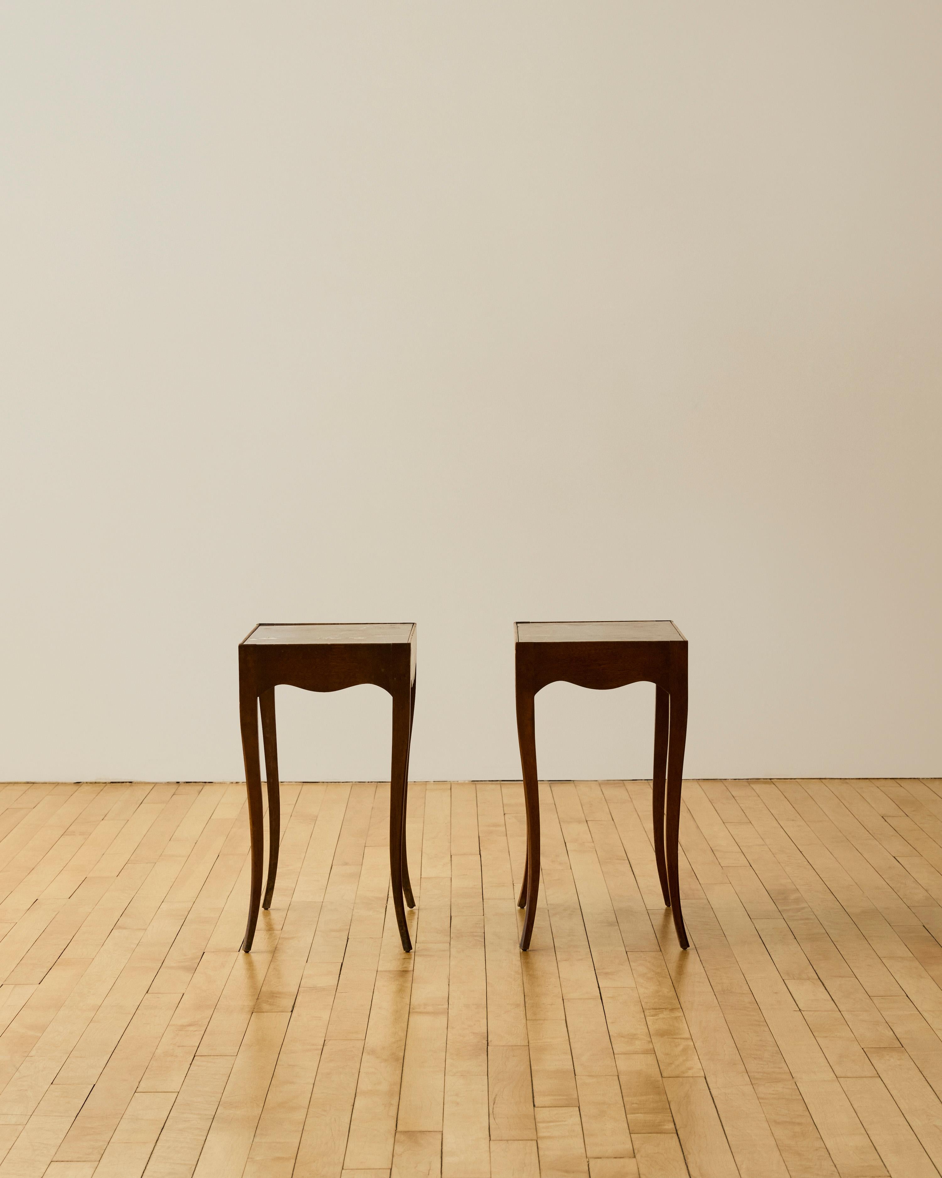 Pair of French provincial mahogany side tables featuring dark burgundy marble inset and scallop detailing.