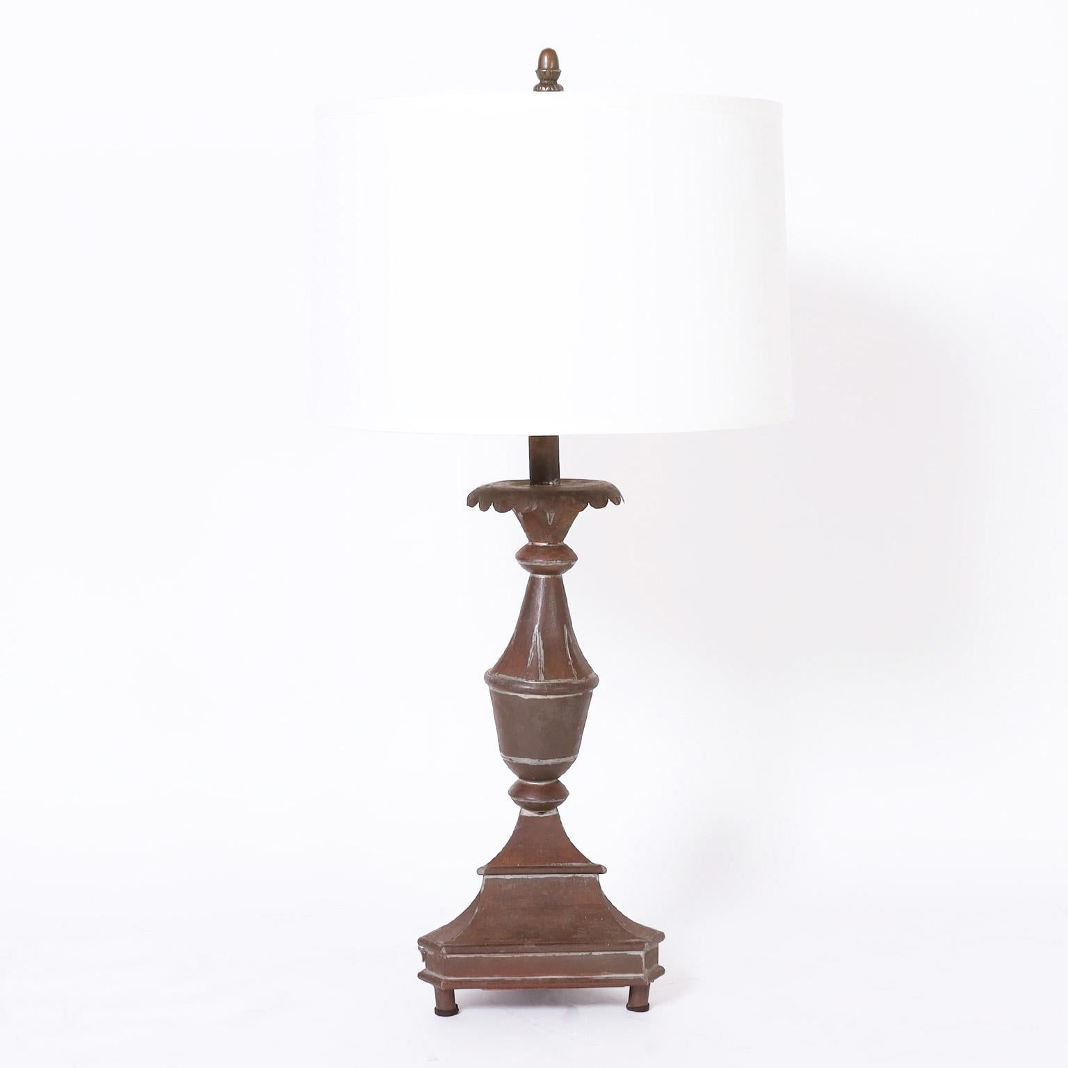 Pair of 19th century large scale candlesticks converted to table lamps, hand crafted with tin in a rustic neoclassic form with an acquired time worn oxidized finish.