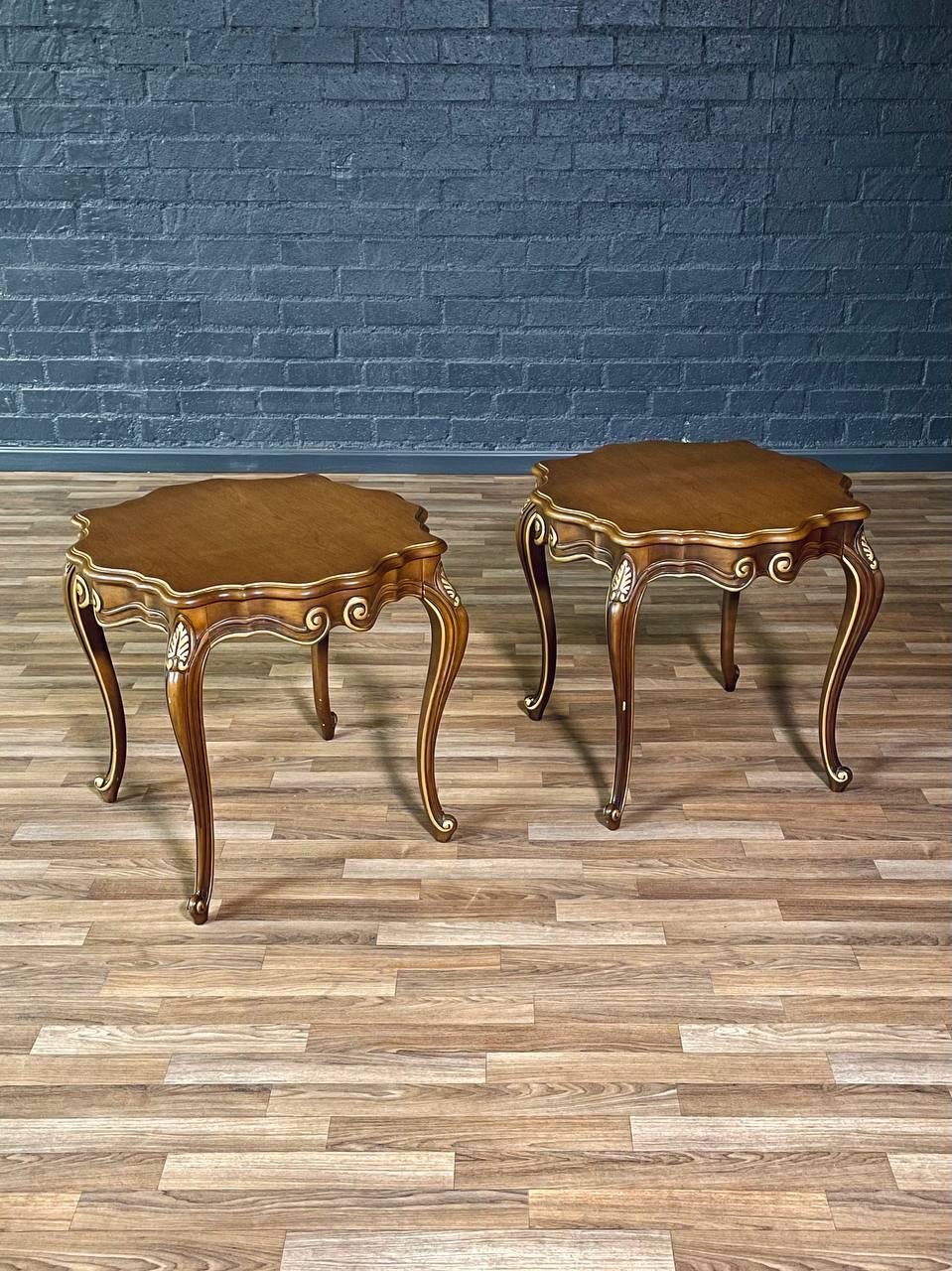 Condition: Original Vintage Condition 
Materials: Walnut, Gilt Painted Carved Accents

These French Provincial walnut side tables reflect the mid-20th century American revival of European elegance, blending romantic curves with approachable charm.