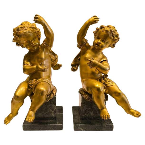 Reproduction Putti Pair of French putti in gilt and chiseled bronze on a green marble base ...