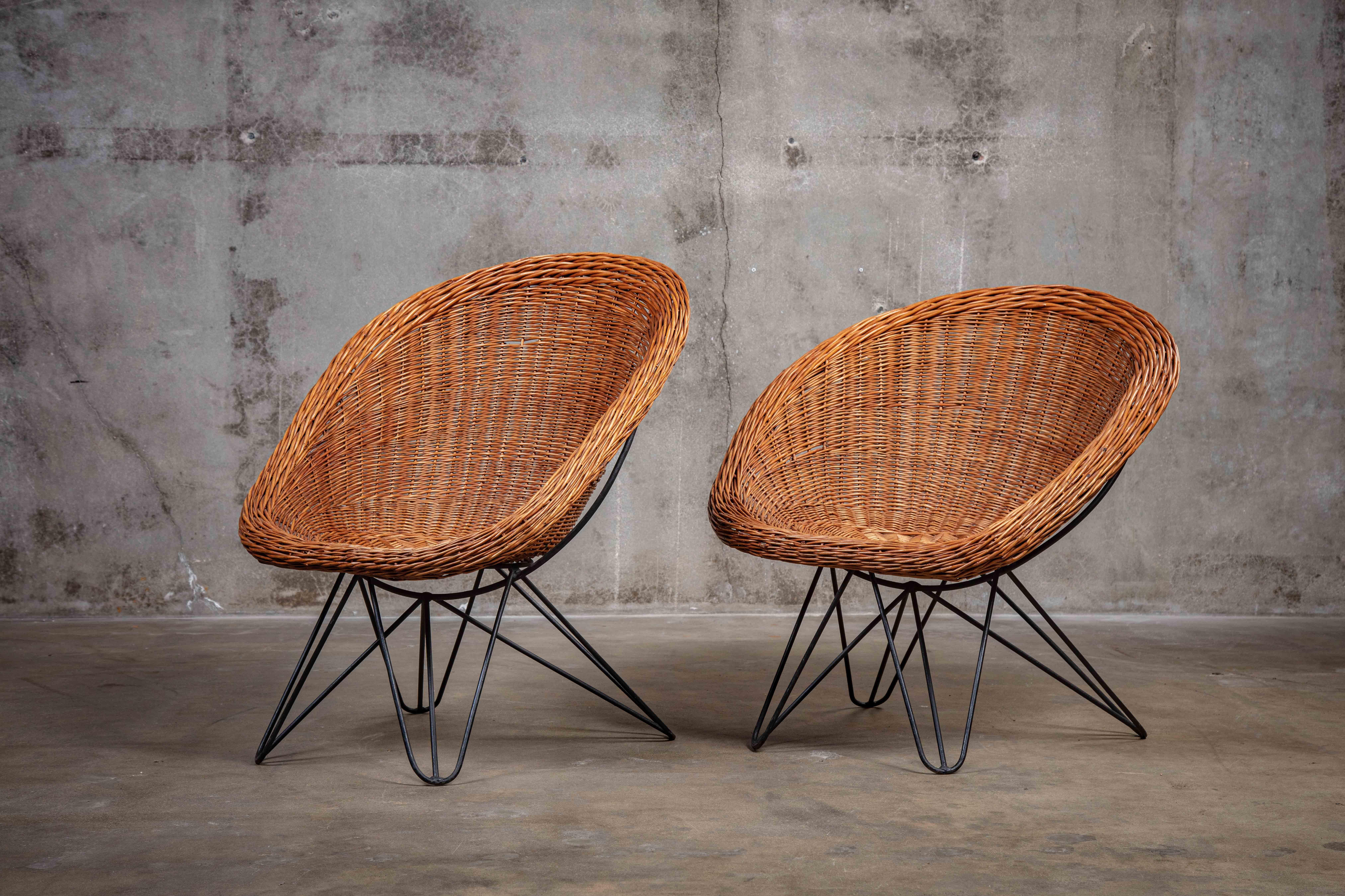Pair of French rattan and iron barrel form chairs, 1960s

Measures: Chair 1: 32 1/2