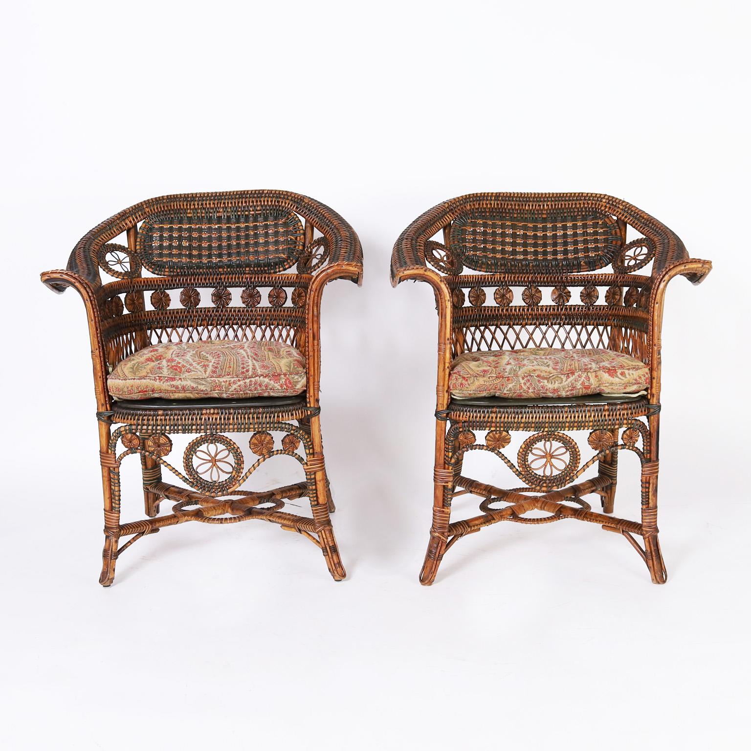 Impressive pair of antique French rattan and reed cafe chairs with bent wood frames decorated with painted and natural reed wrapped rattan in a graceful form with sturdy cross stretchers. Signed Pierre Leroux.