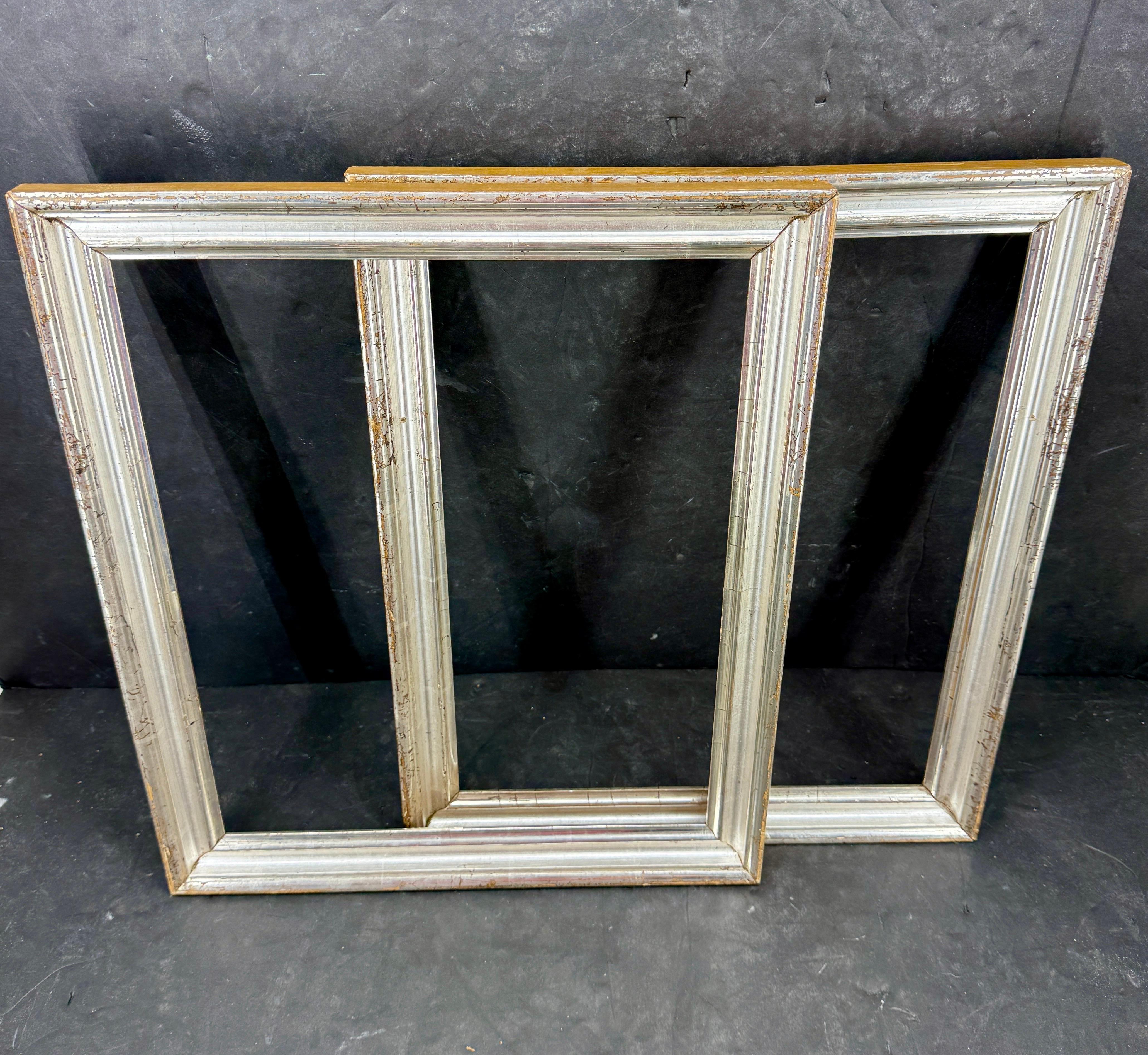 As found in Europe, a pair of impressive rectangular antique wooden frames in silver gilt leaf with great patina. This set would be suitable for most style artwork including prints, watercolors as well as oil on board paintings. Wonderful to stand