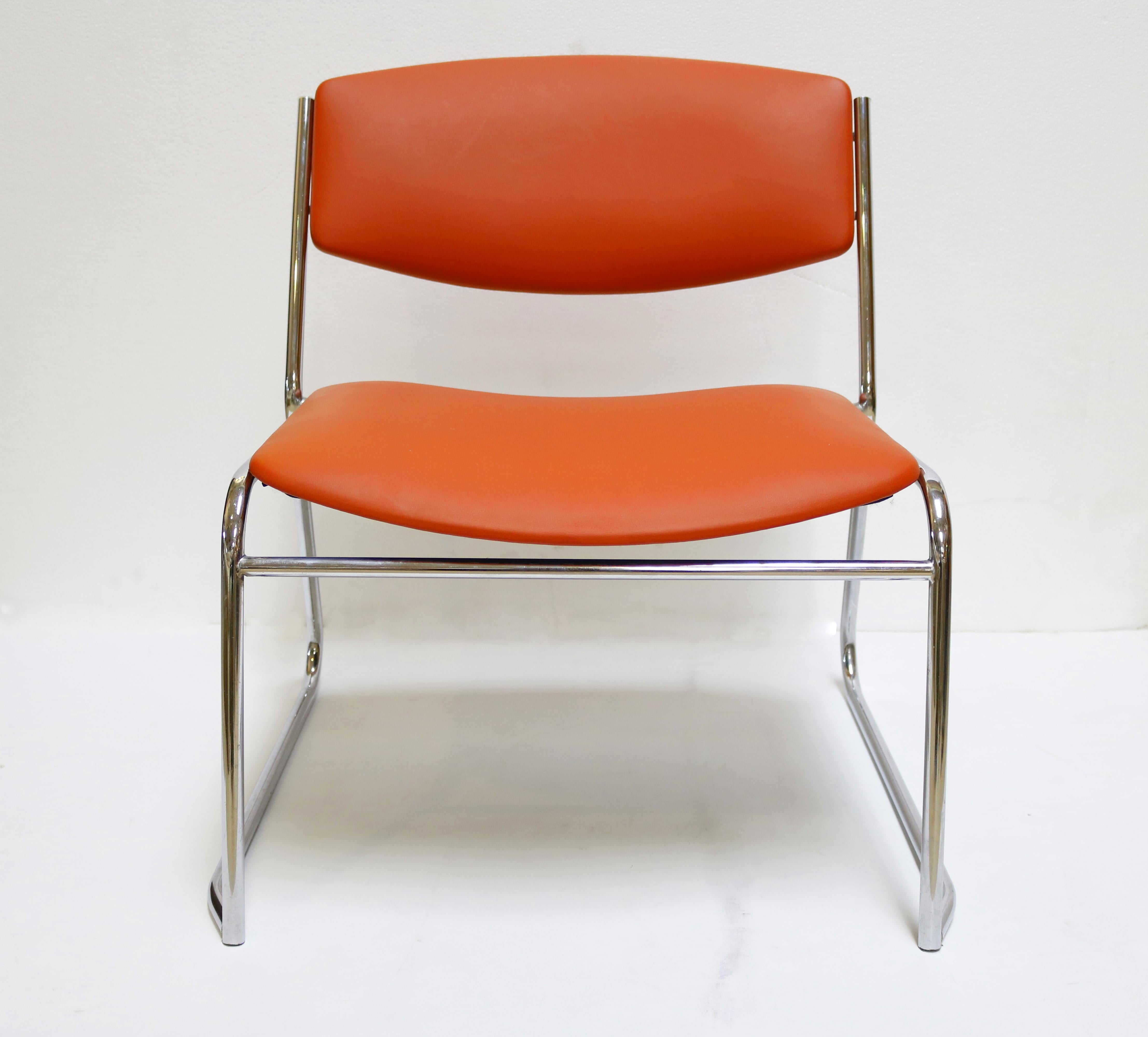 These sleek, chrome framed slipper chairs are upholstered in orange-red fabric and lean back in lounge fashion.
They are very comfortable!