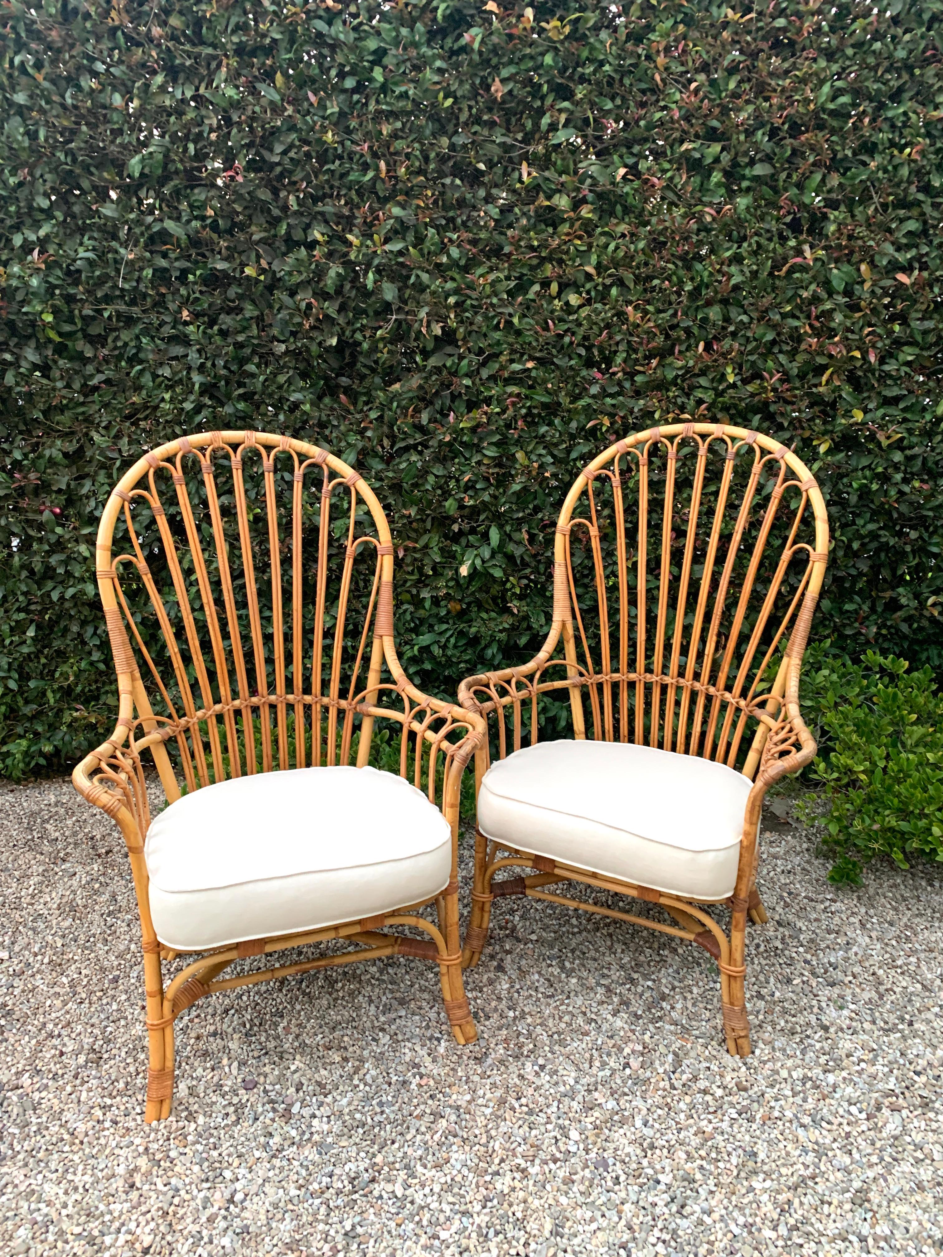 French rattan and bamboo wing chairs. A compliment to any living space, lanai or outdoor setting. The bamboo and rattan are in wonderful vintage condition and all loose ends have been re-lashed, the cushions have been re-upholstered in linen with a