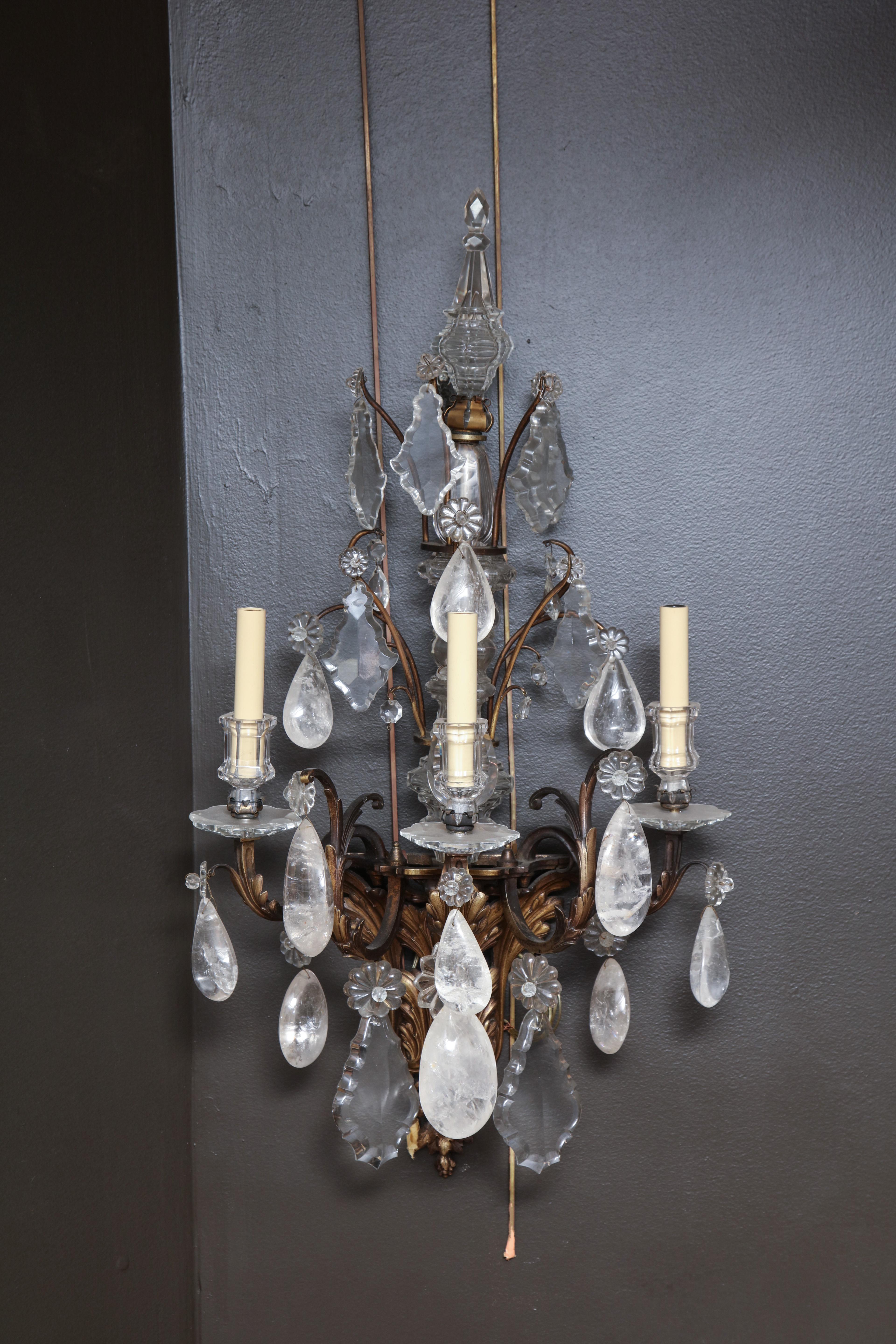 A fine and large pair of 19th century French Regency bronze, crystal and rock crystal three-light wall appliques or sconces.