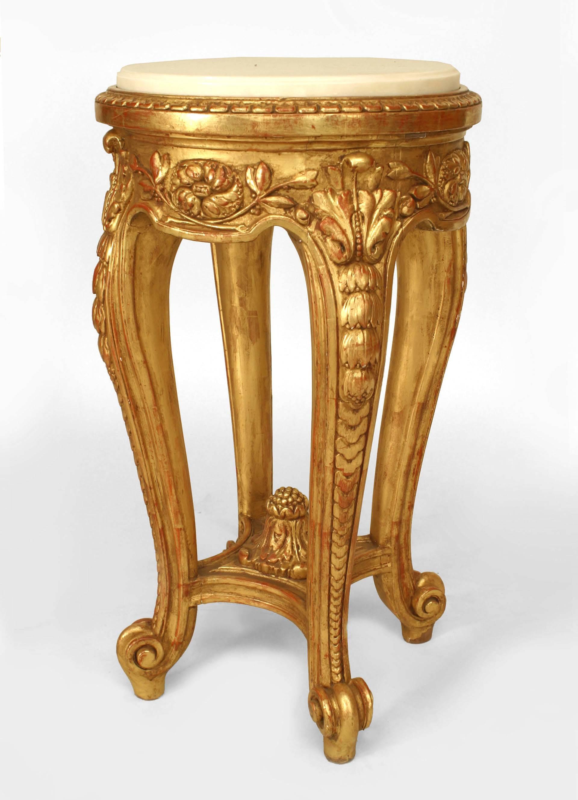 Pair of French Regence-style (19th Century) gilt and carved end tables with stretcher and round white marble tops.
