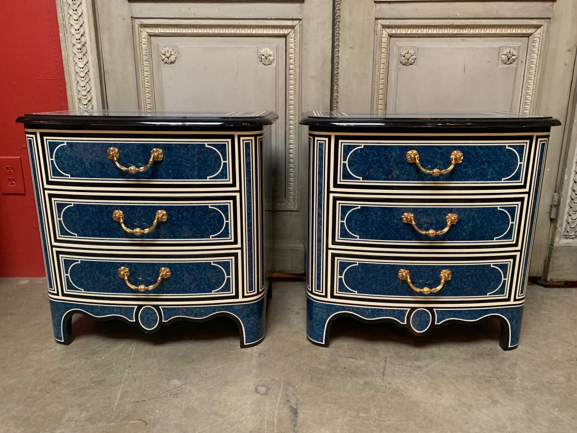 A pair of French painted and lacqured chest of drawers in the Regence style, with a blue white and black finish and gilt broze hardware. These stylish commodes were made in Paris in the 1980s. They will be great night stands or flanking a sofa.