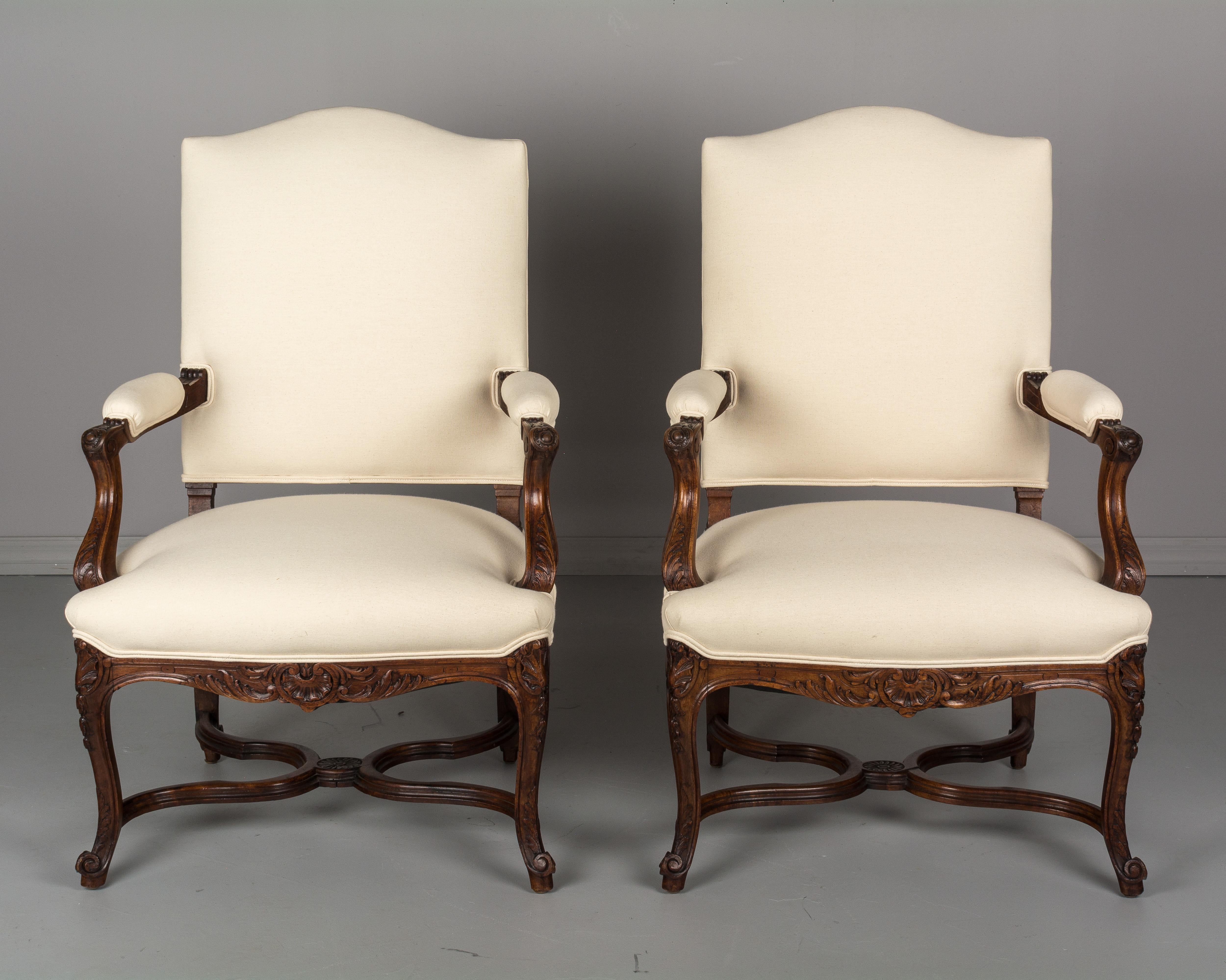 Hand-Carved Pair of French Regency Style Fauteuils or Armchairs