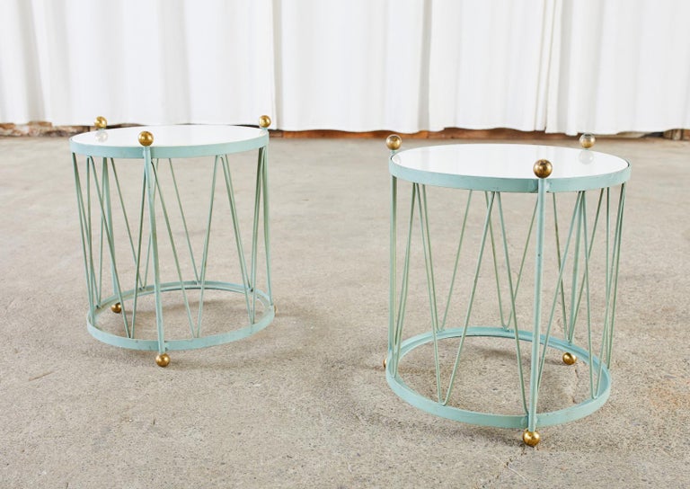 Whimsical pair of French iron drum form Regency style side tables or drink tables featuring a milk glass inset on top. The tables are crafted from wrought iron with cylindrical frames. Decorated with a zig-zag pattern like a drum and supported with