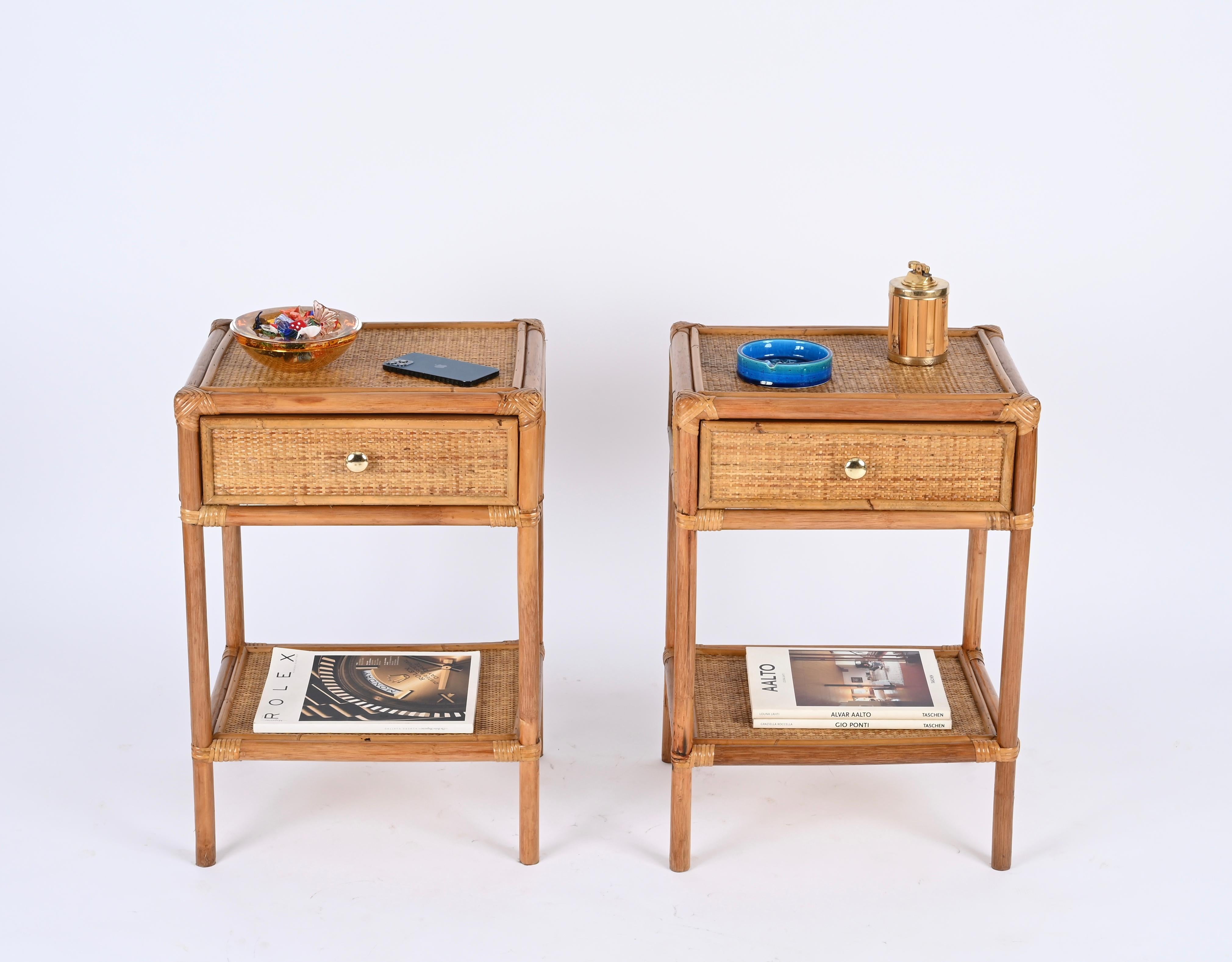 Delightful pair of Mid-Century nightstands in bamboo and hand-woven rattan wicker with brass handles. These lovely bedside tables were designed in Italy during the 1970s.

These stunning nightstands are fully made in bamboo canes and enriched all