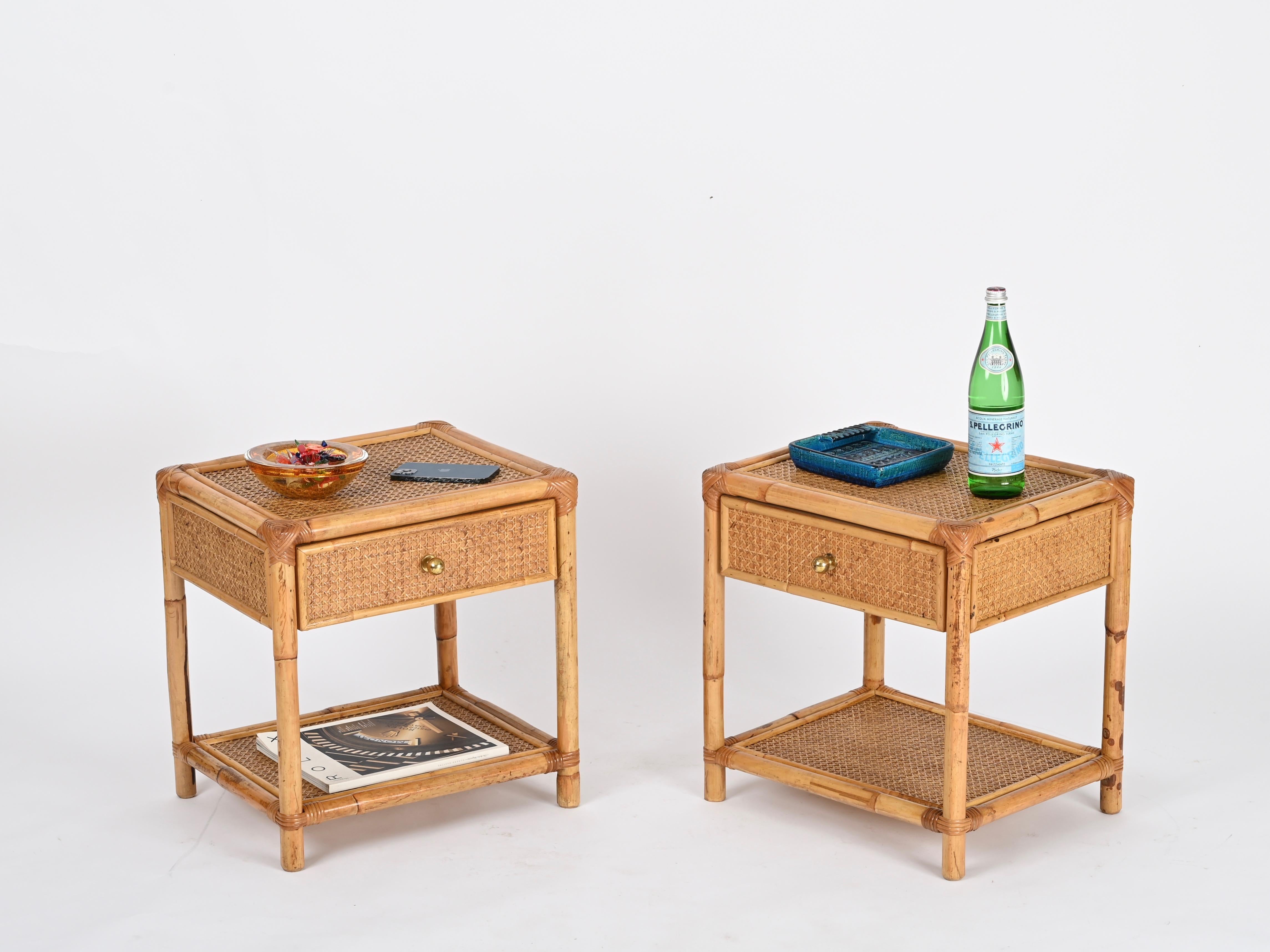 Delightful pair of Mid-Century nightstands in bamboo, Vienna Straw and hand-woven rattan wicker with brass handles. These charming organic bedside tables were designed in Italy during the 1970s.

These stunning French Riviera style nightstands, are