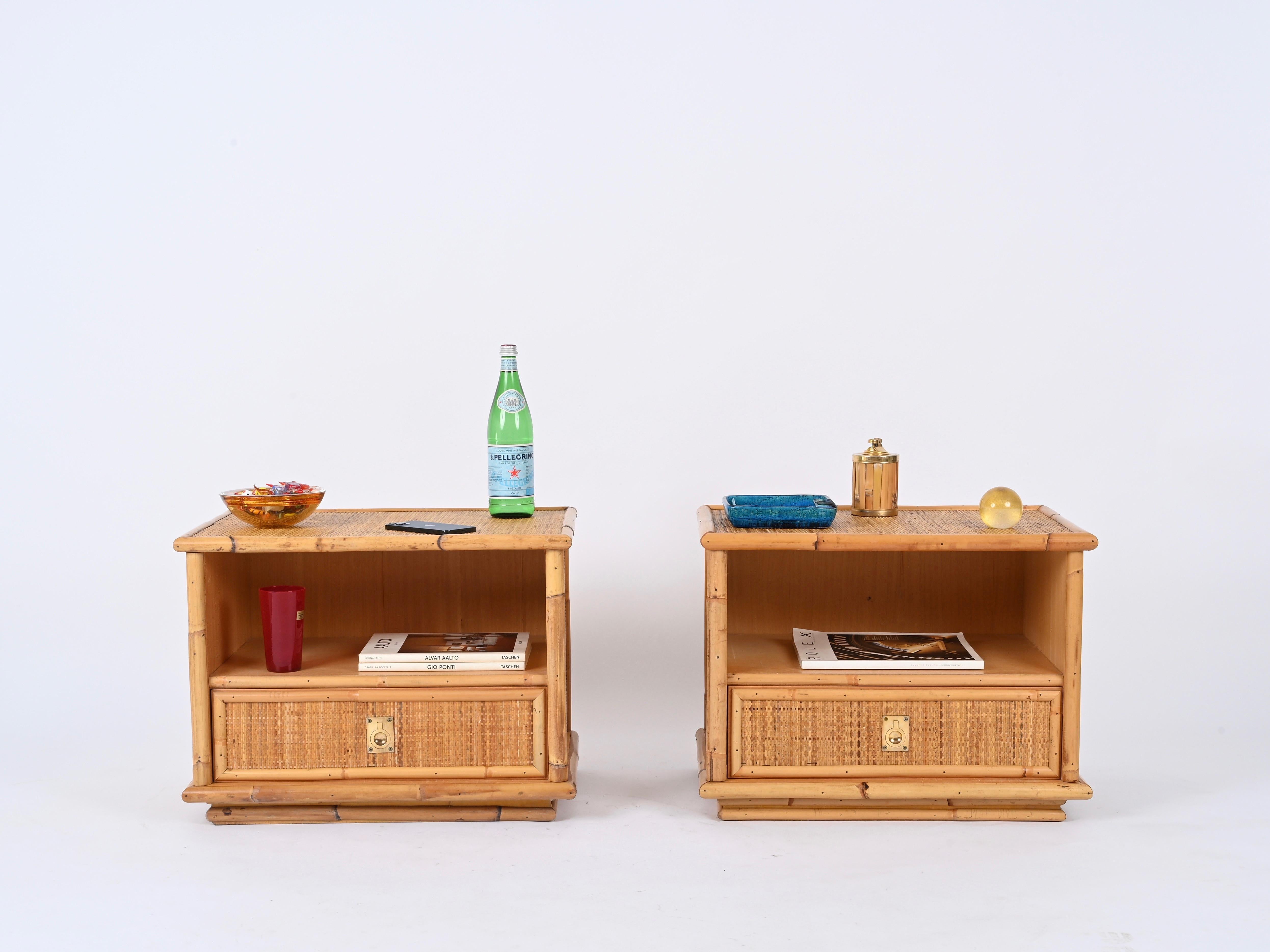 Marvelous pair of Mid-Century nightstands in rattan and woven wicker with brass handles. These lovely bedside tables are signed inside the drawers and were produced by Dal Vera, in Italy during the 1970s.  

These charming nightstands are fully made