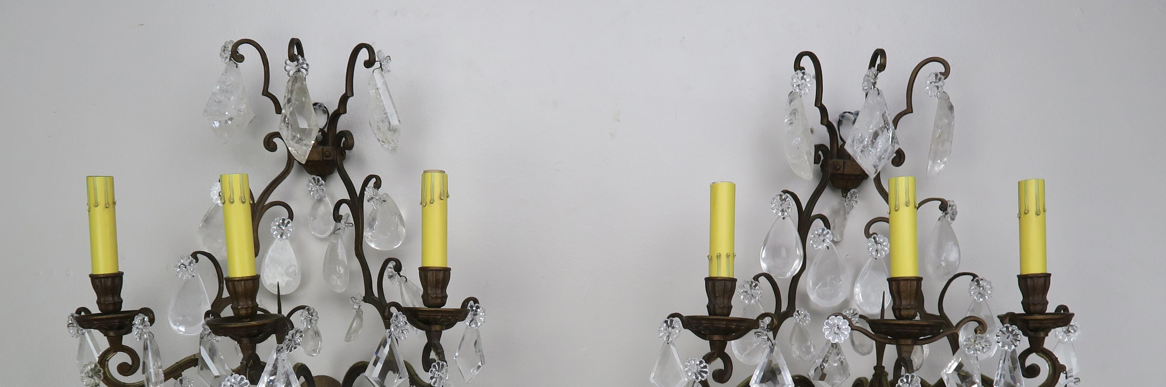 Pair of 3-light French rock crystal sconces adorned with both kite shape rock crystal and almond shape rock crystal throughout. The sconces are newly rewired and ready to install.