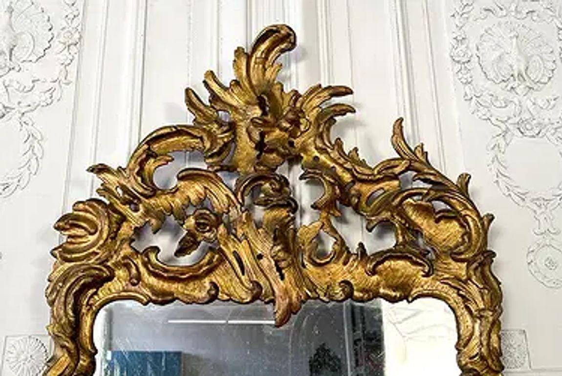 Pair of 18th century French Rococo period carved and giltwood mirrors. Circa 1780. Note original Mercury glass. These mirrors weren’t just functional—they were status symbols, often placed above console tables or between windows in salons and