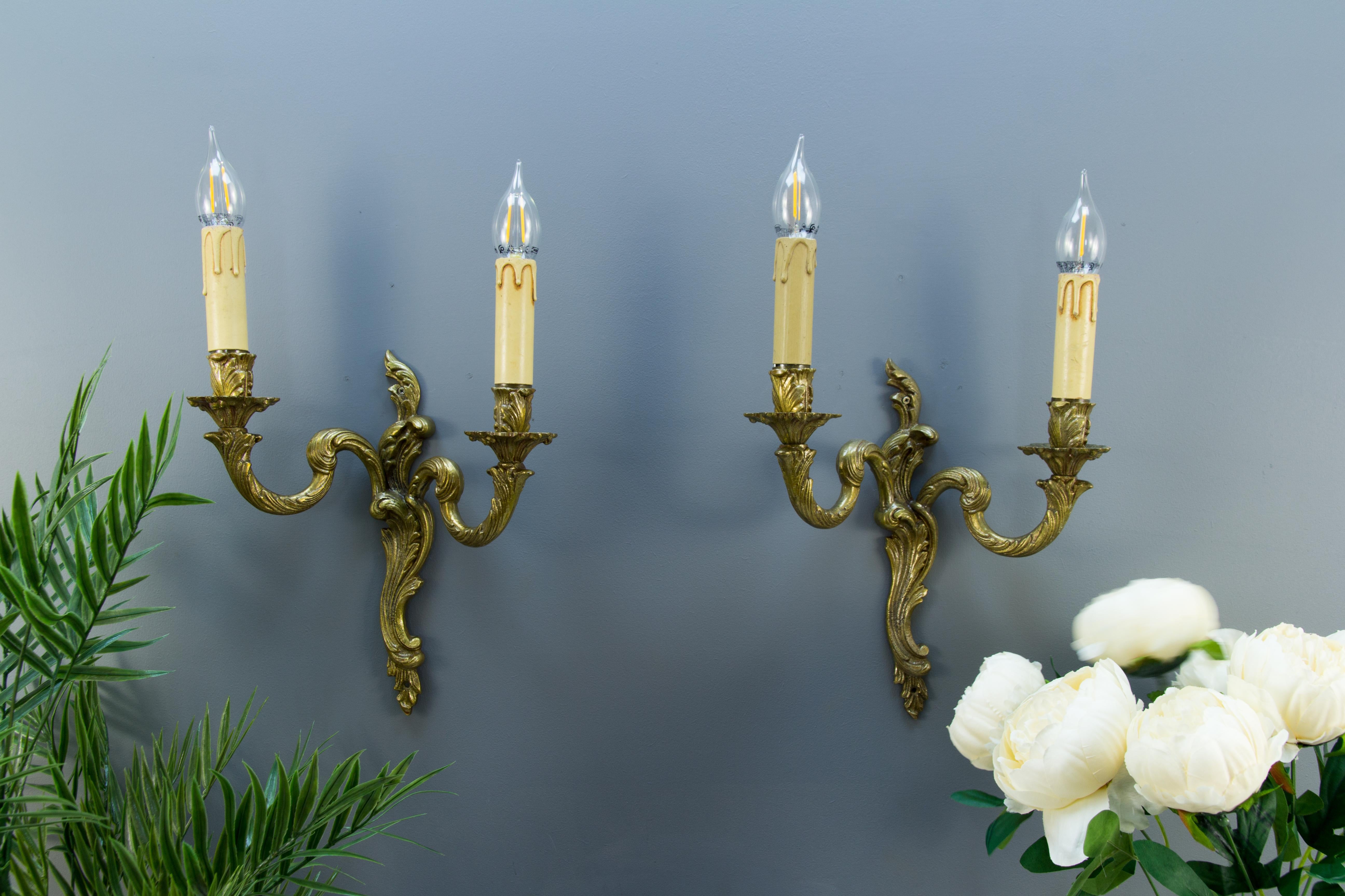 A pair of Rococo or Louis XV-style ornate wall sconces with curvy asymmetrical acanthus leaf-like bronze scrolls. Each sconce has two arms, each with one socket for an E14-size light bulb. France, the first half of the 20th century.
Dimensions: