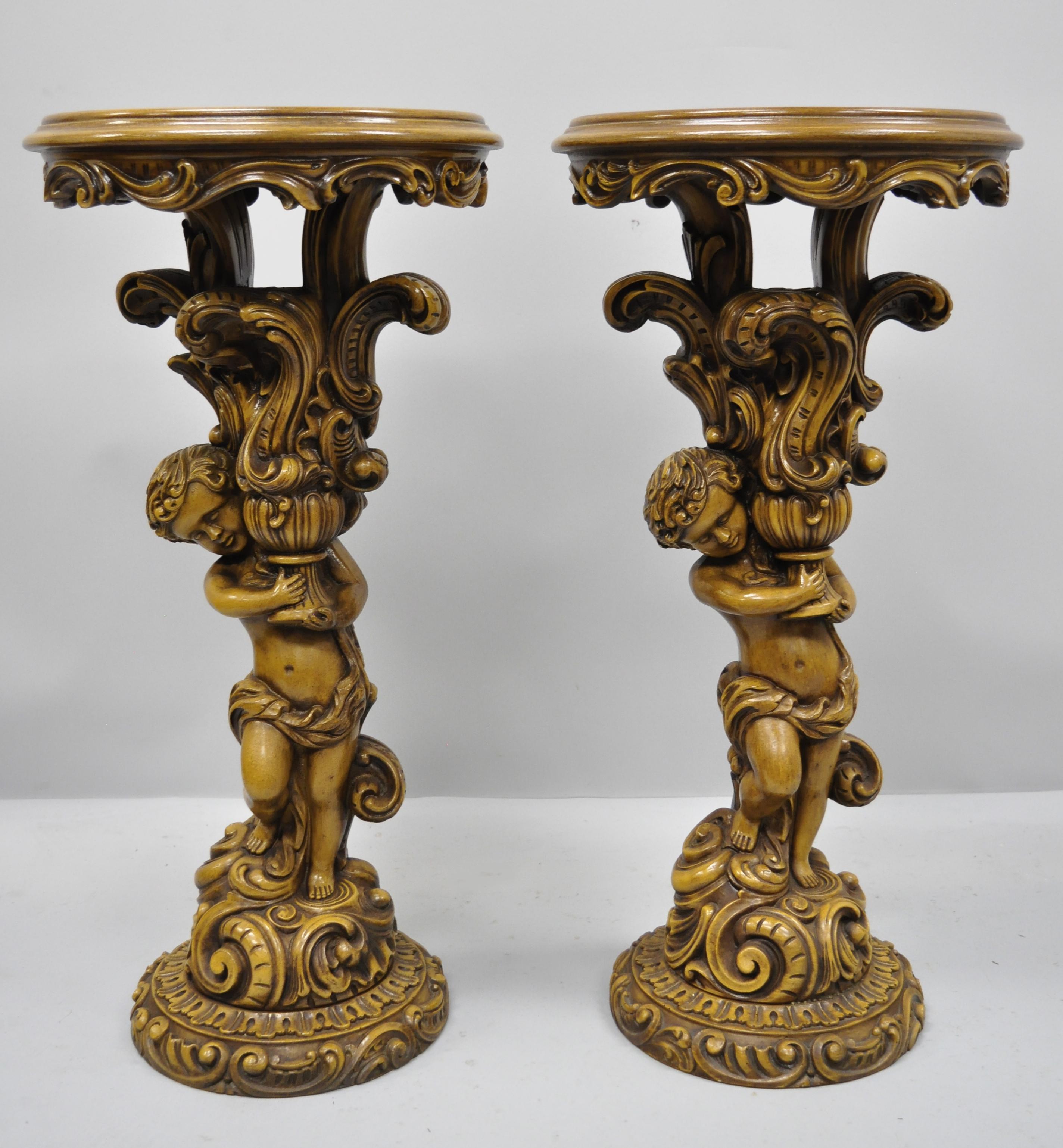 Pair of French Rococo style figural Cherub Angel pedestal plant stands table. Items feature round inset glass tops, figural cherub support columns, and great style and form, circa mid to late 20th century. Measurements: 33