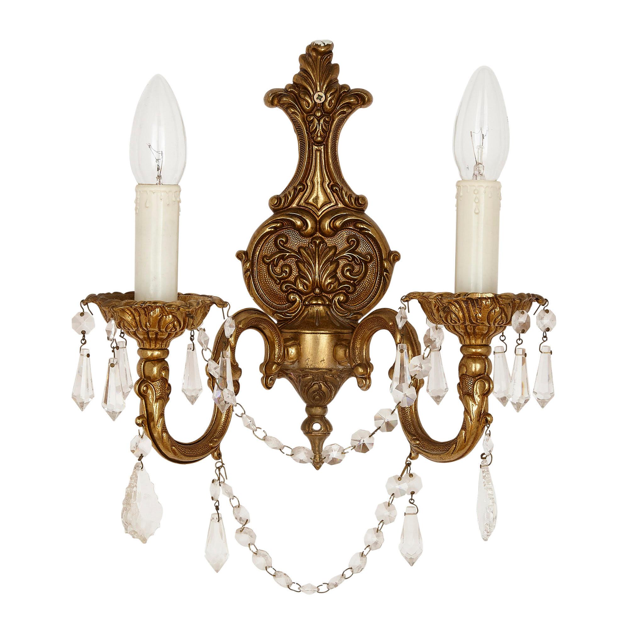 Pair of French Rococo style gilt metal sconces
French, 20th Century
Measures: Height 34cm, width 29cm, depth 15m

The sconces in this pair are crafted in the elegant Rococo style. Each sconce features a gilt metal backplate adorned with moulded
