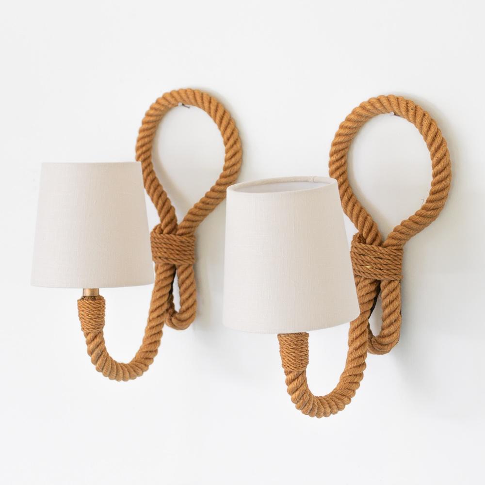 Unique pair of vintage French rope sconces by French designers Adrien Audoux and Frida Minet. Thick twisted rope arm extending to hold single socket and shade. Large loop detail on back. Newly rewired with brown twisted cord, hand switch and plug.