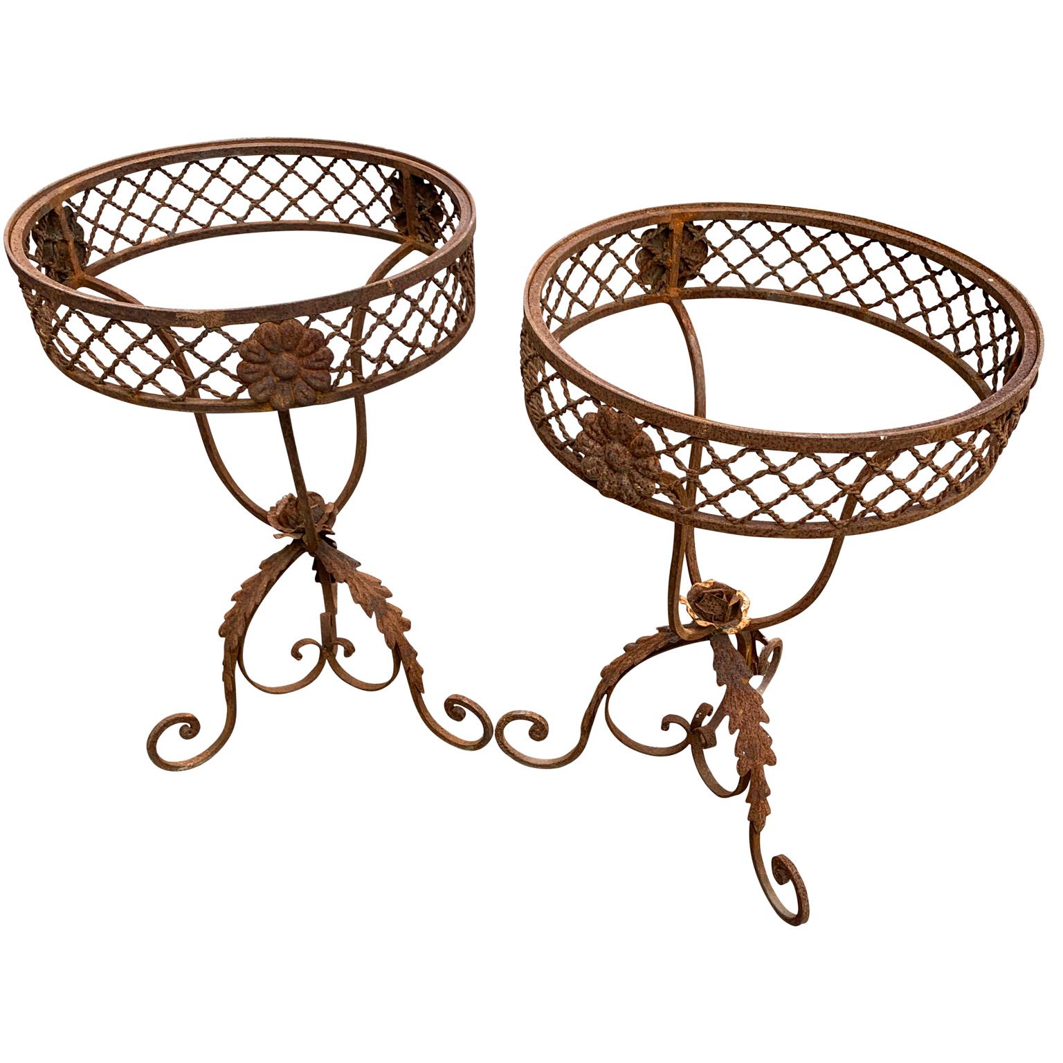 Pair of French round wrought iron and marble garden bistro tables.