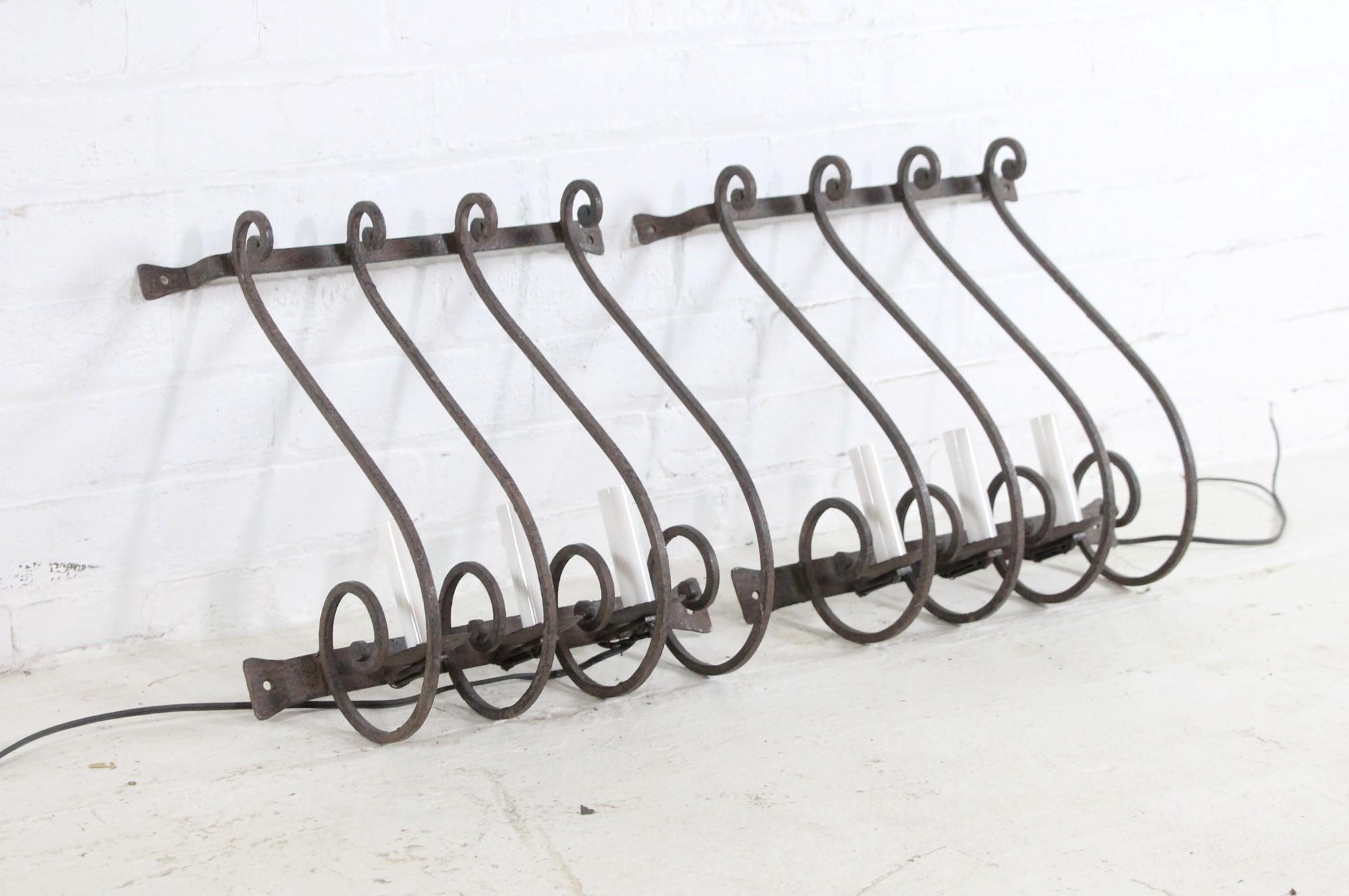 Early 20th Century French blacksmith worked wrought iron wall sconces Three lights each. Cleaned and rewired. Please note, this item is located in our Scranton, PA location.