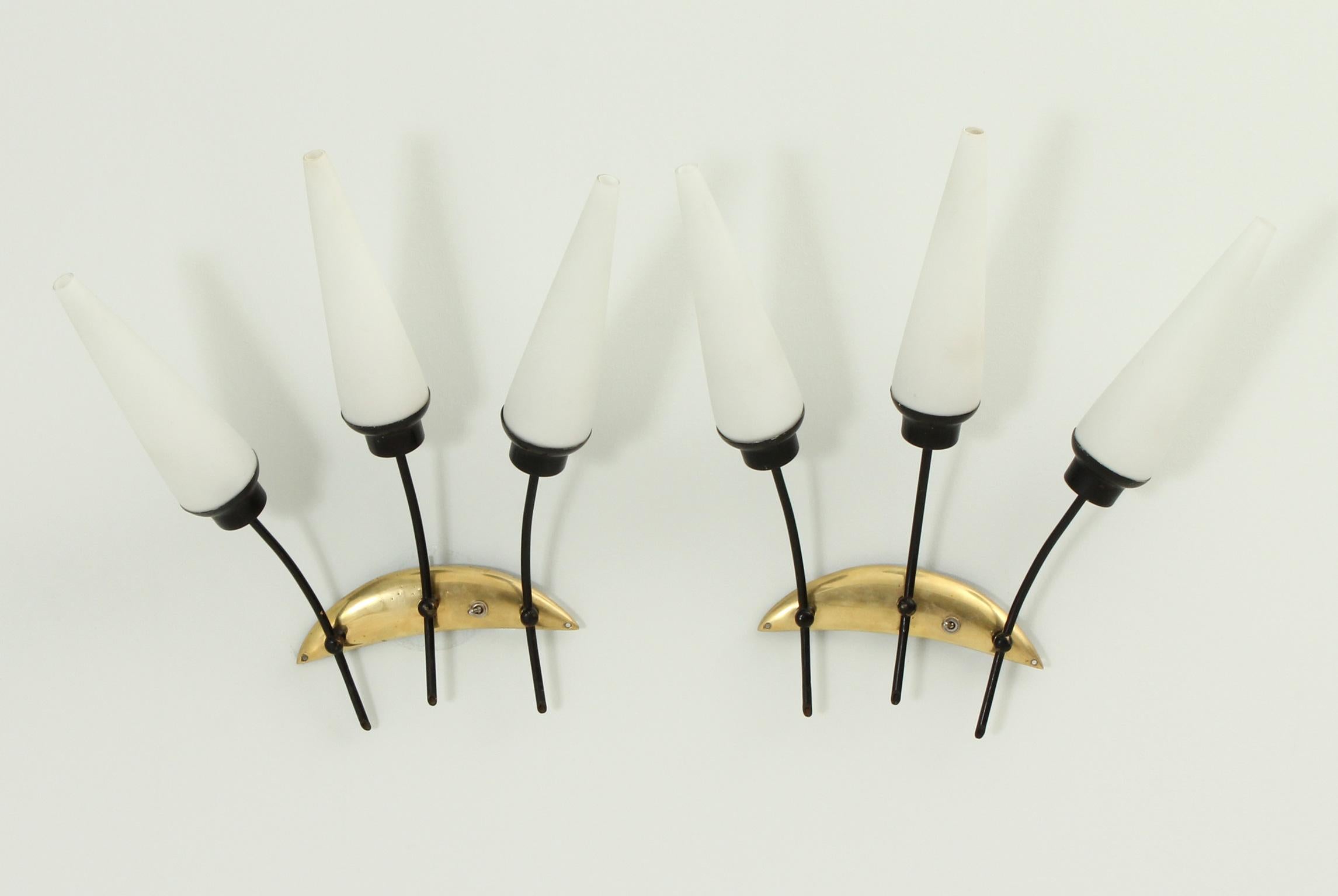 Pair of sconces attributed to french company Arlus, 1950's. Matt opal glass diffusers, black enamelled metal and brass.