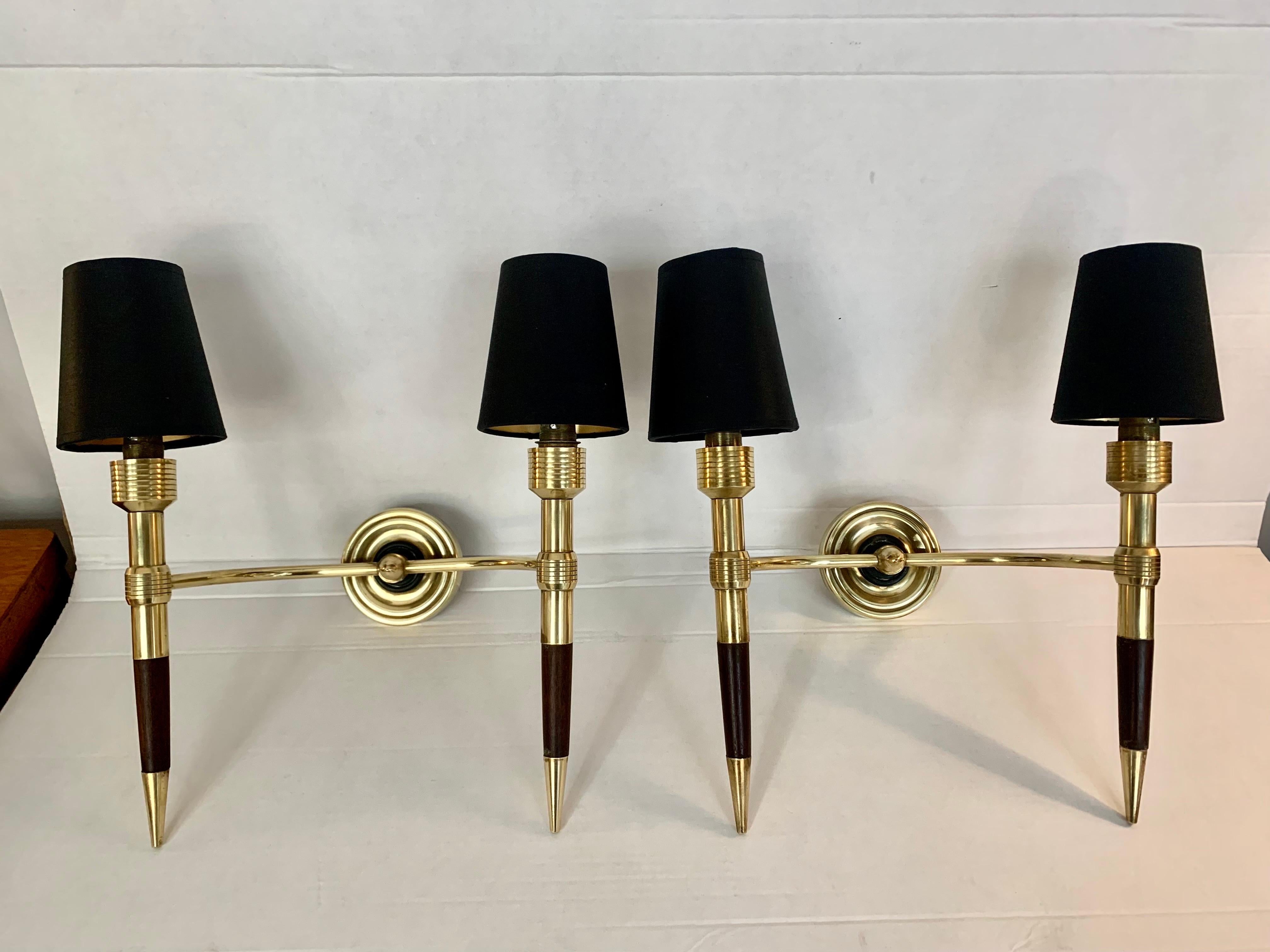 A pair of elegant French wall sconces, from Maison Lancel, in golden brass and lacquered wood, double light and black and golden interior shades, proven and renovated operation.