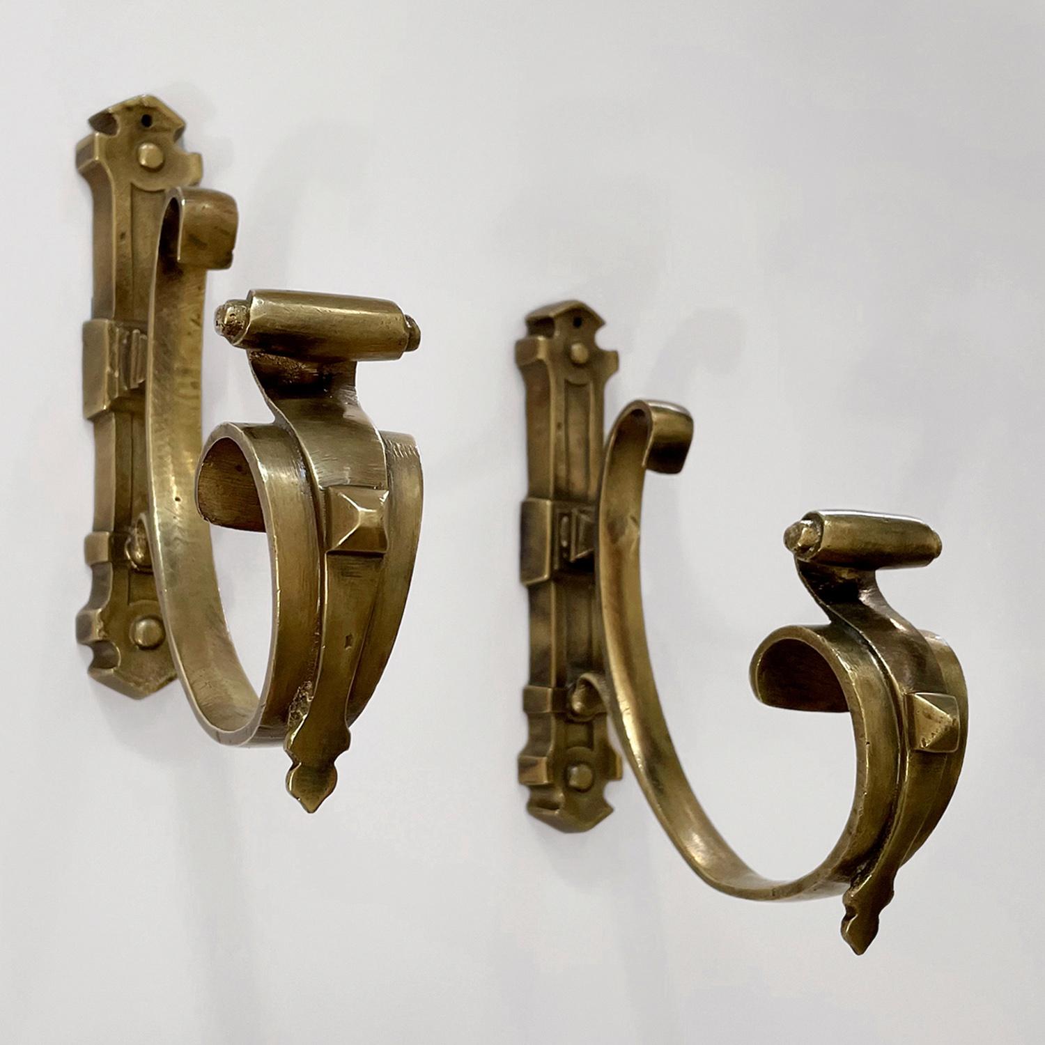 Pair of French bronze studded wall hooks
France, early 20th century
These beautifully sculpted bronze wall hooks are a dramatic statement piece
Wonderful attention to detail throughout
Heavy weight deep J hooks are adorned with studded rivets
Each
