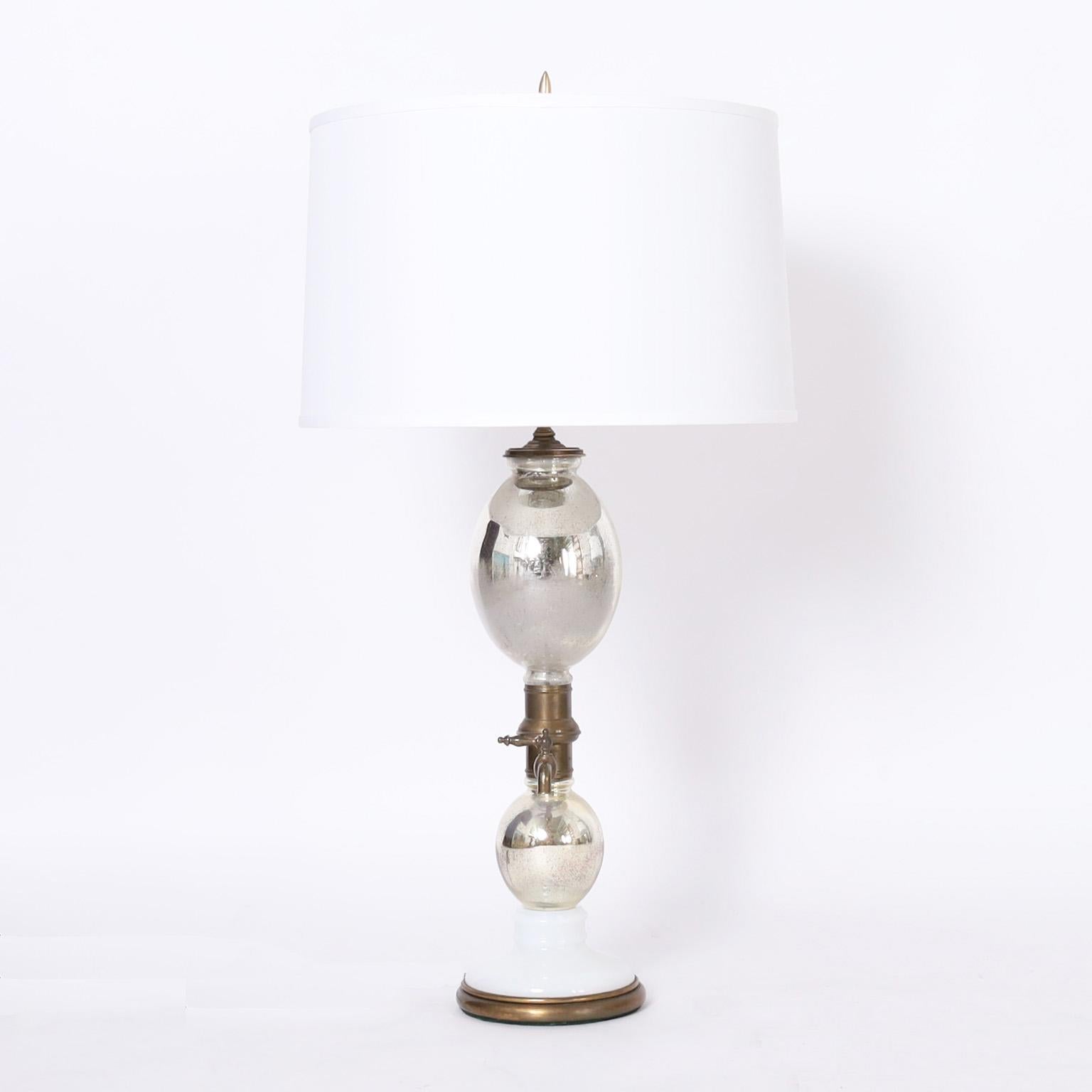 Standout pair of vintage table lamps with a classic seltzer bottle form having mercury glass bulbs, brass hardware, and milk glass bases.