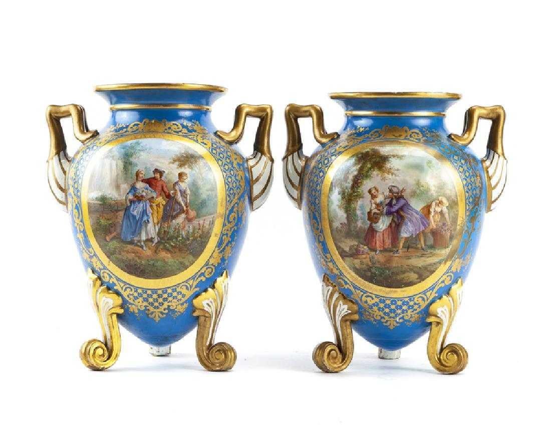 Fabulous pair of French Sèvres style porcelain vases, late 19th century.
The ovoid body of the vase depicts a romantic scene in the park flanked by gilt handles, on three scrolling acanthus feet.

 