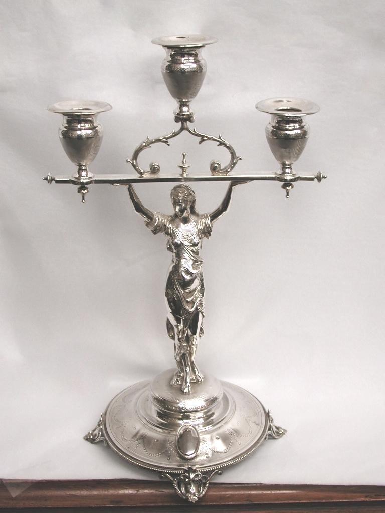 Pair of French silver 3-light candelabra, dated circa 1860.
Decorated with classical maidens and typical French engine turning with swags on the bases.
The maidens are cast as well as the feet and scrolls holding the top capitals and sconce.
The