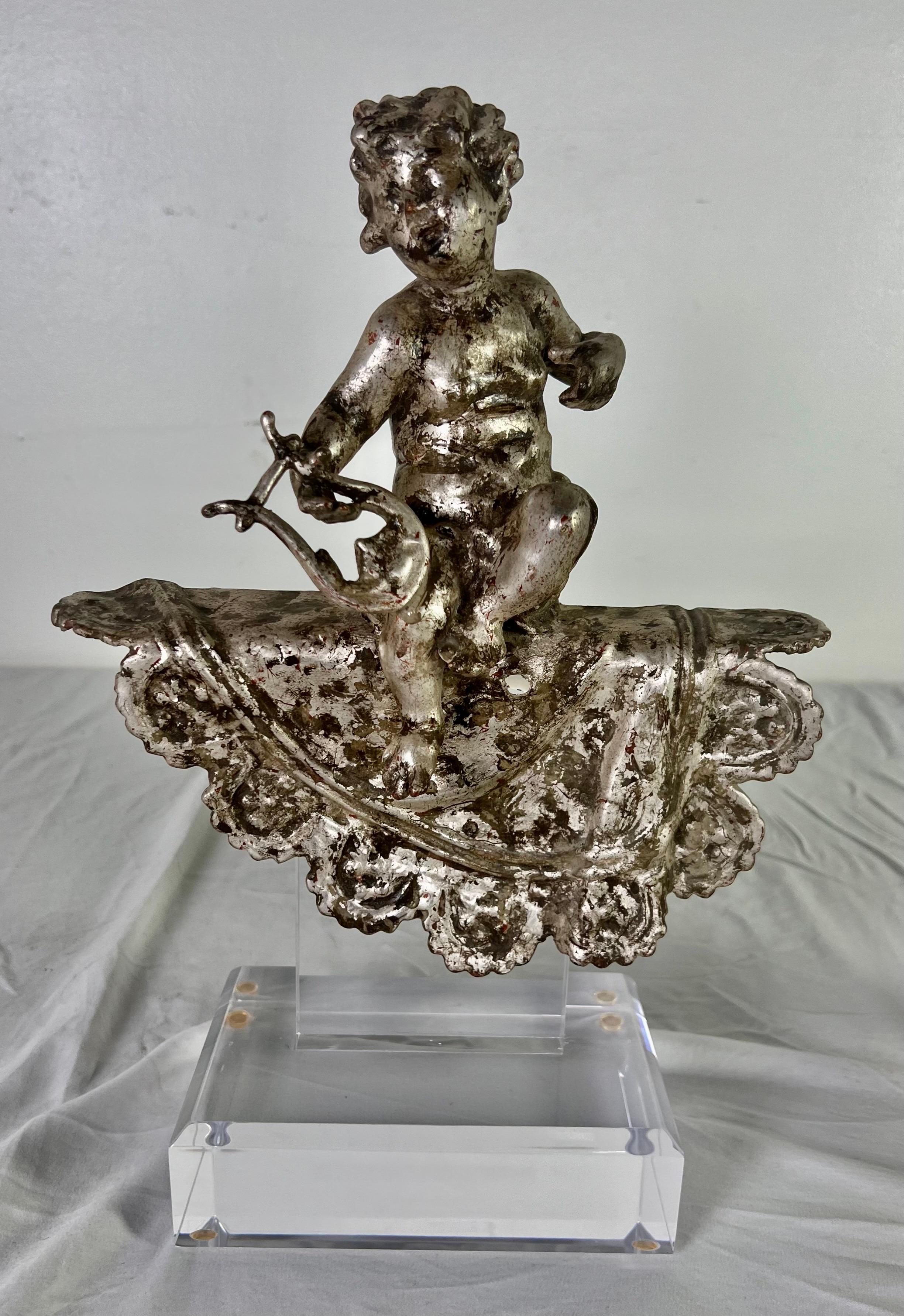 Pair of silvered gilt metal architectural elements depicting cherubs.  The cherubs are mounted on a lucite base and are ready for your home.