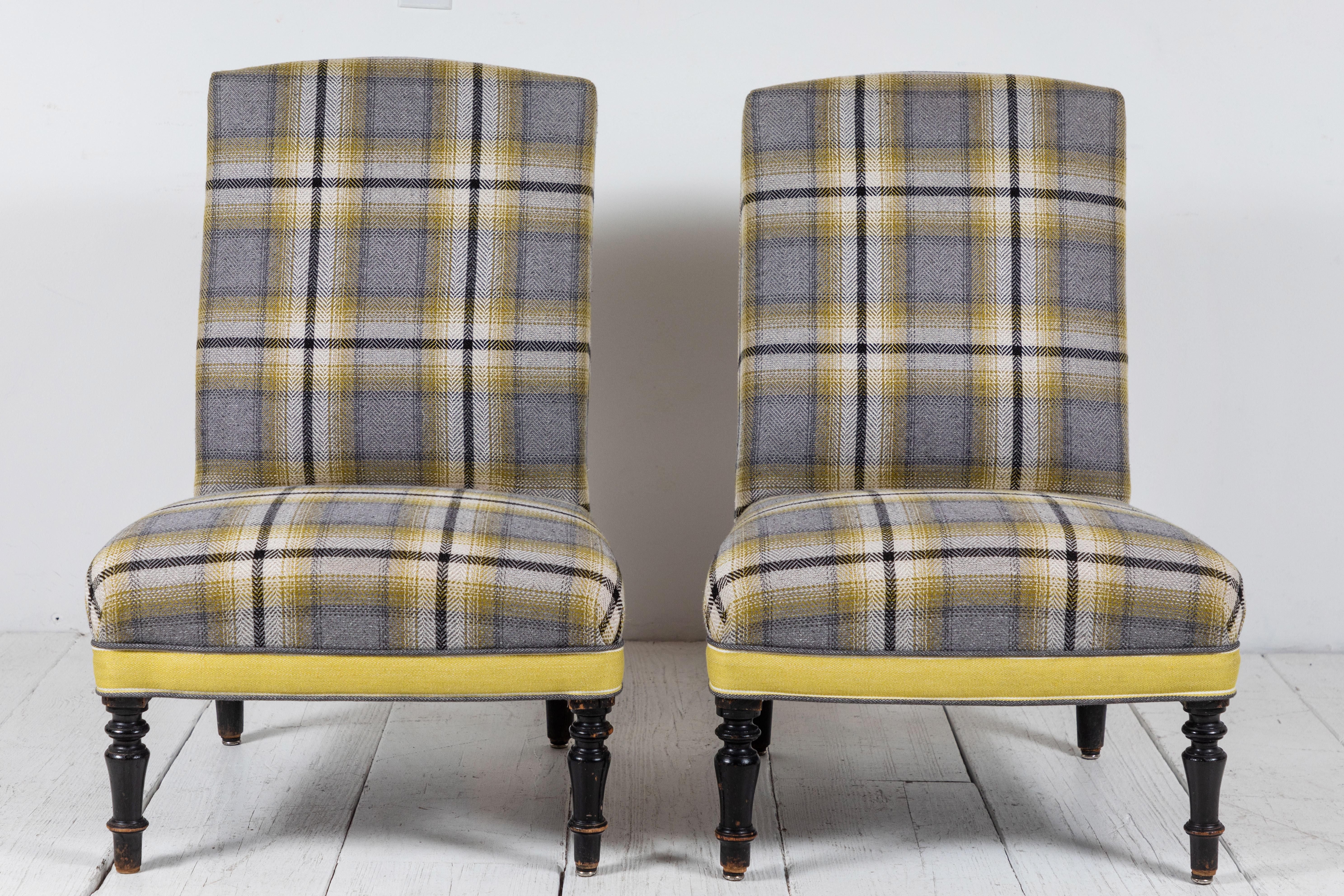 Pair of French slipper chairs in yellow and grey plaid. The chairs sit on original turned legs.
