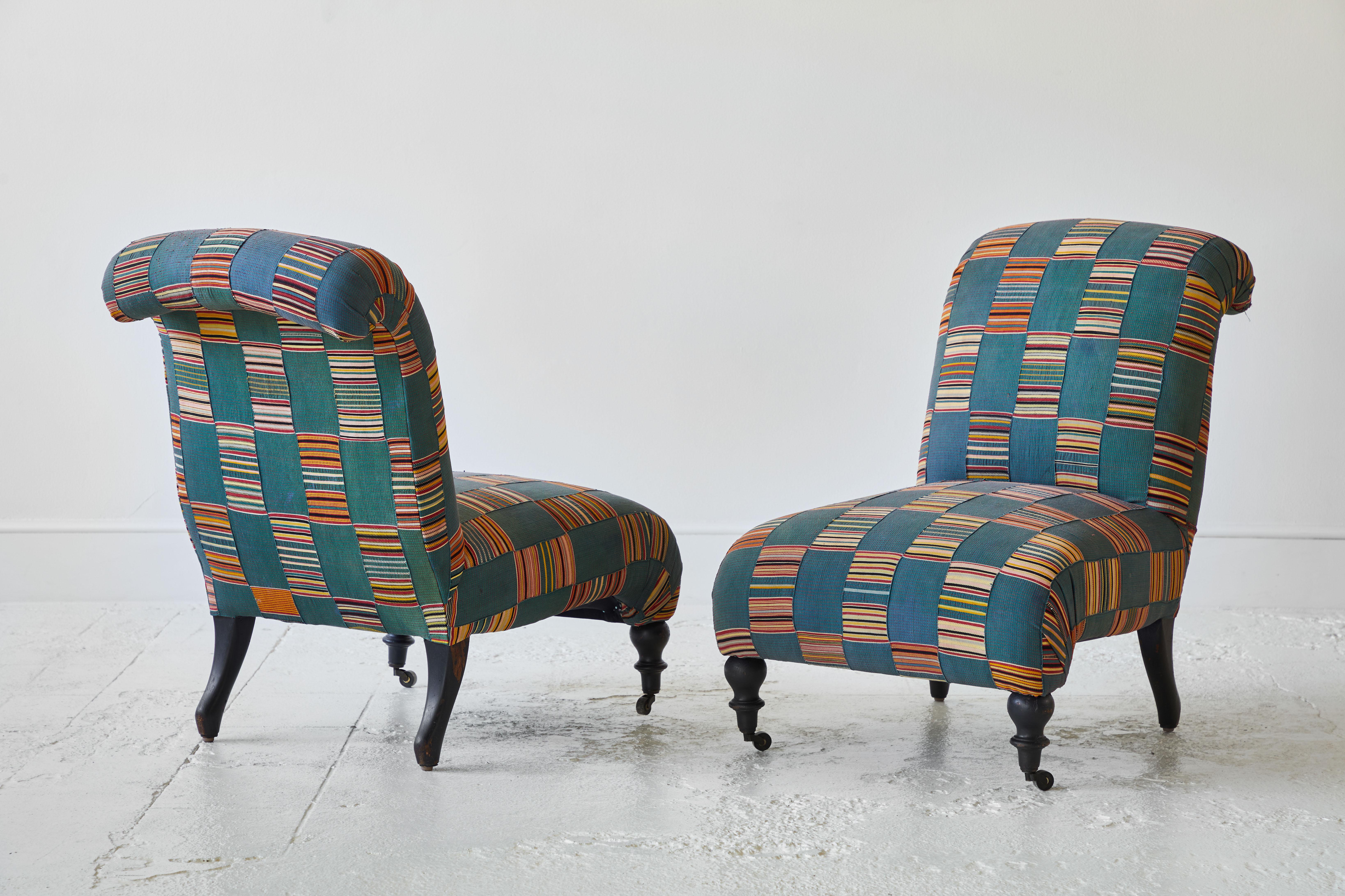 Pair of Classic French slipper chairs upholstered in West African multicolored fabric.