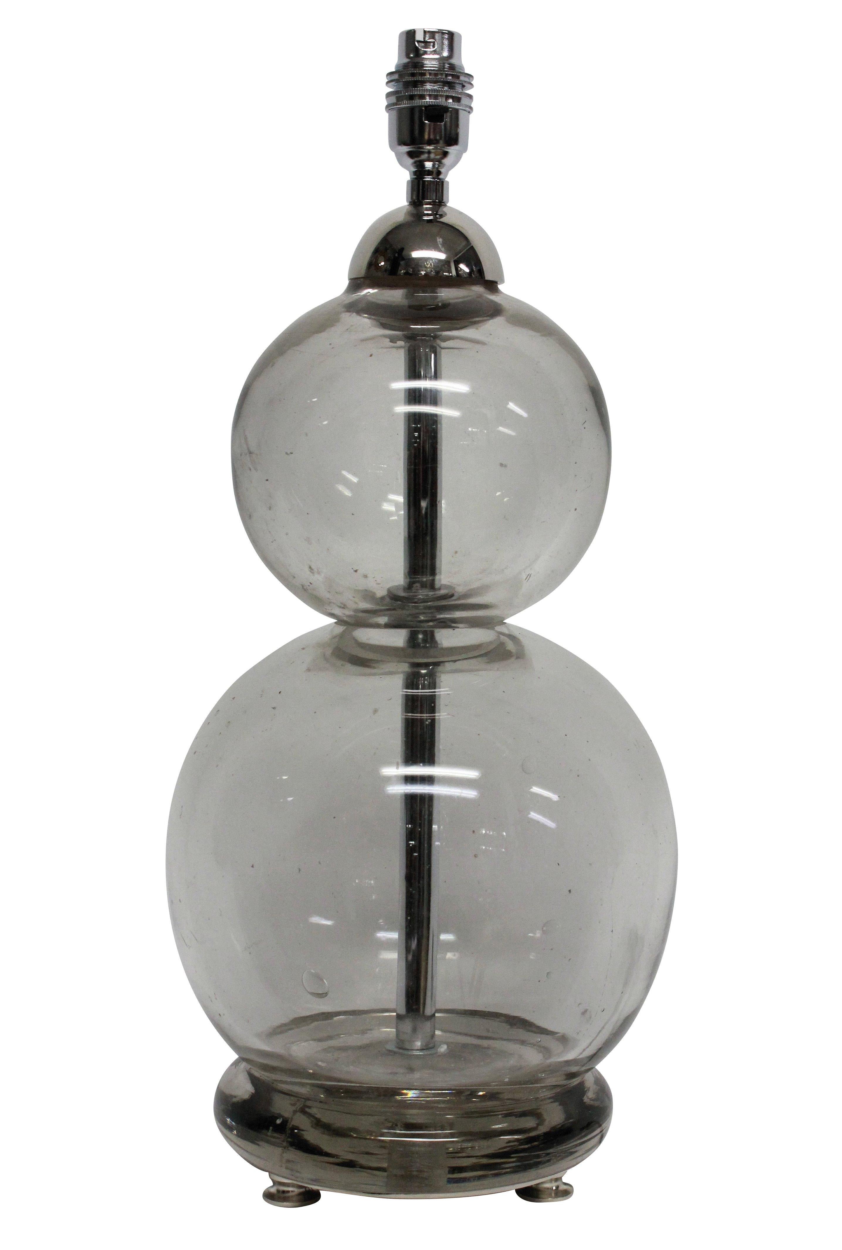A pair of lamps made out of converted French 'Seltzogene' soda siphons. The thick hand blown glass has a nice grey tint. The fittings are silver plate.