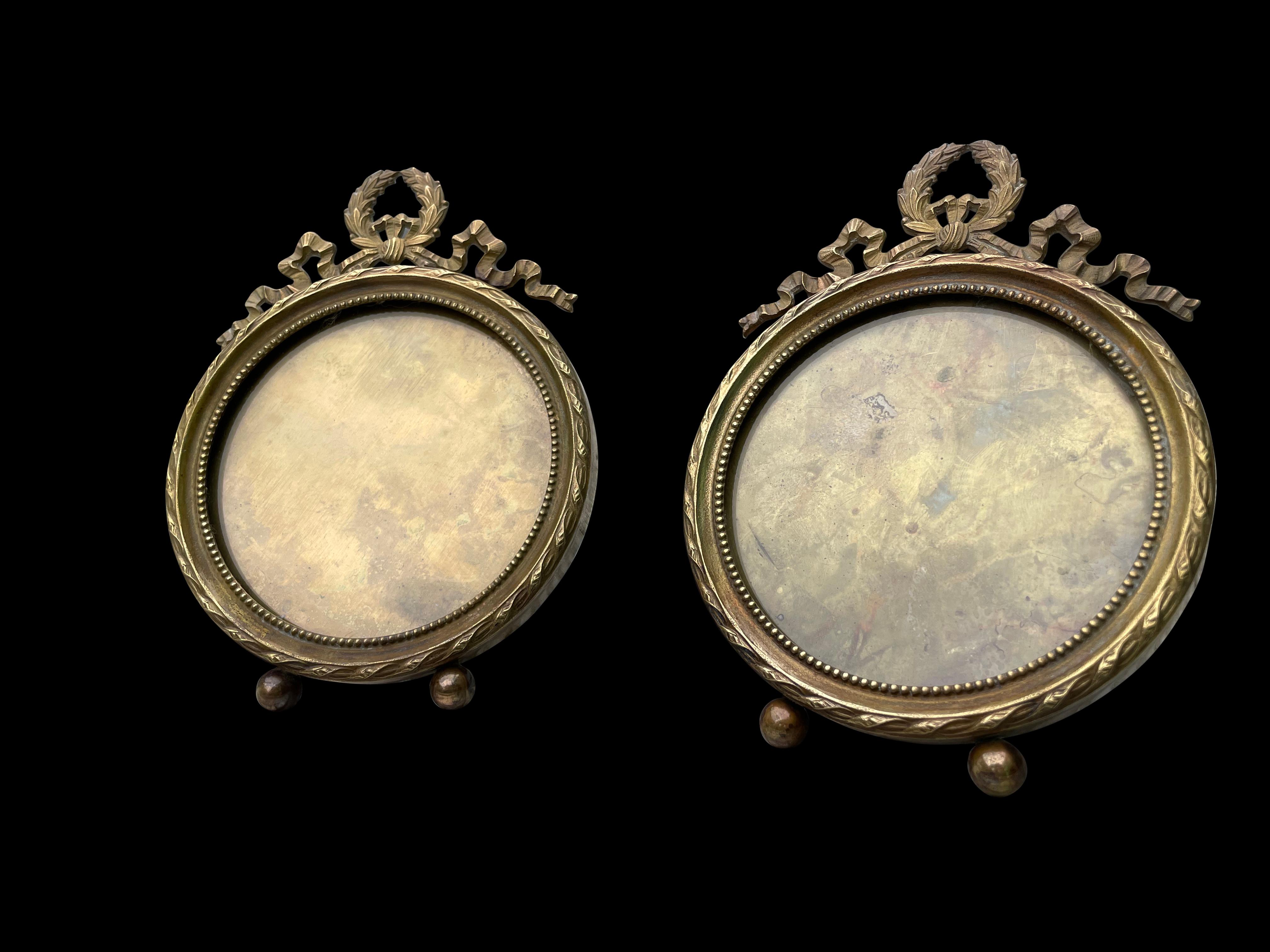 A fine pair of French solid brass Regency style photo-frames, 19th century. Decorated in bowes and swags, this set are a great addition to home decor.