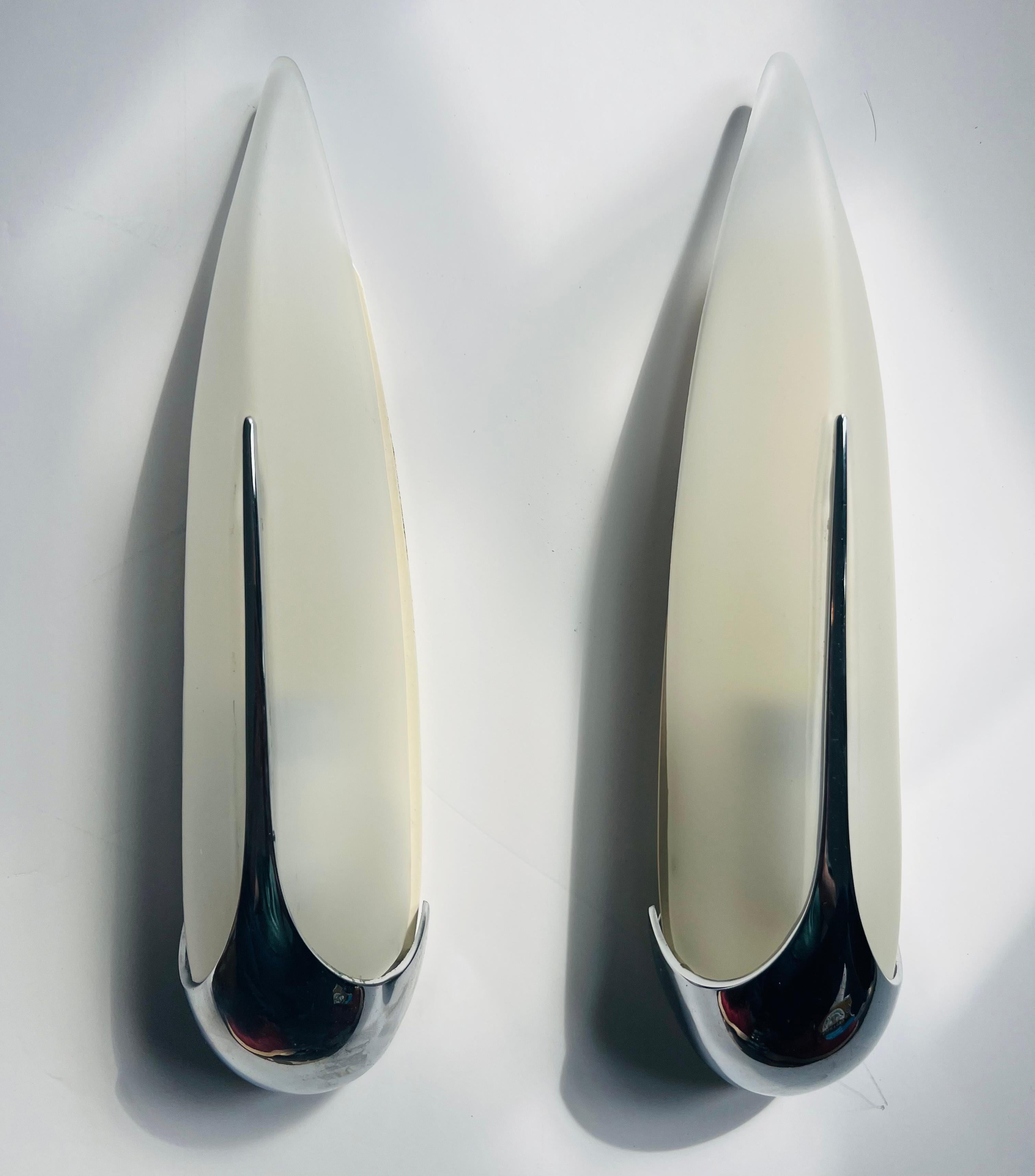 Pair of sleek 1990s space age polished chrome and frosted glass French wall lamps. Newly rewired with candelabra sockets.