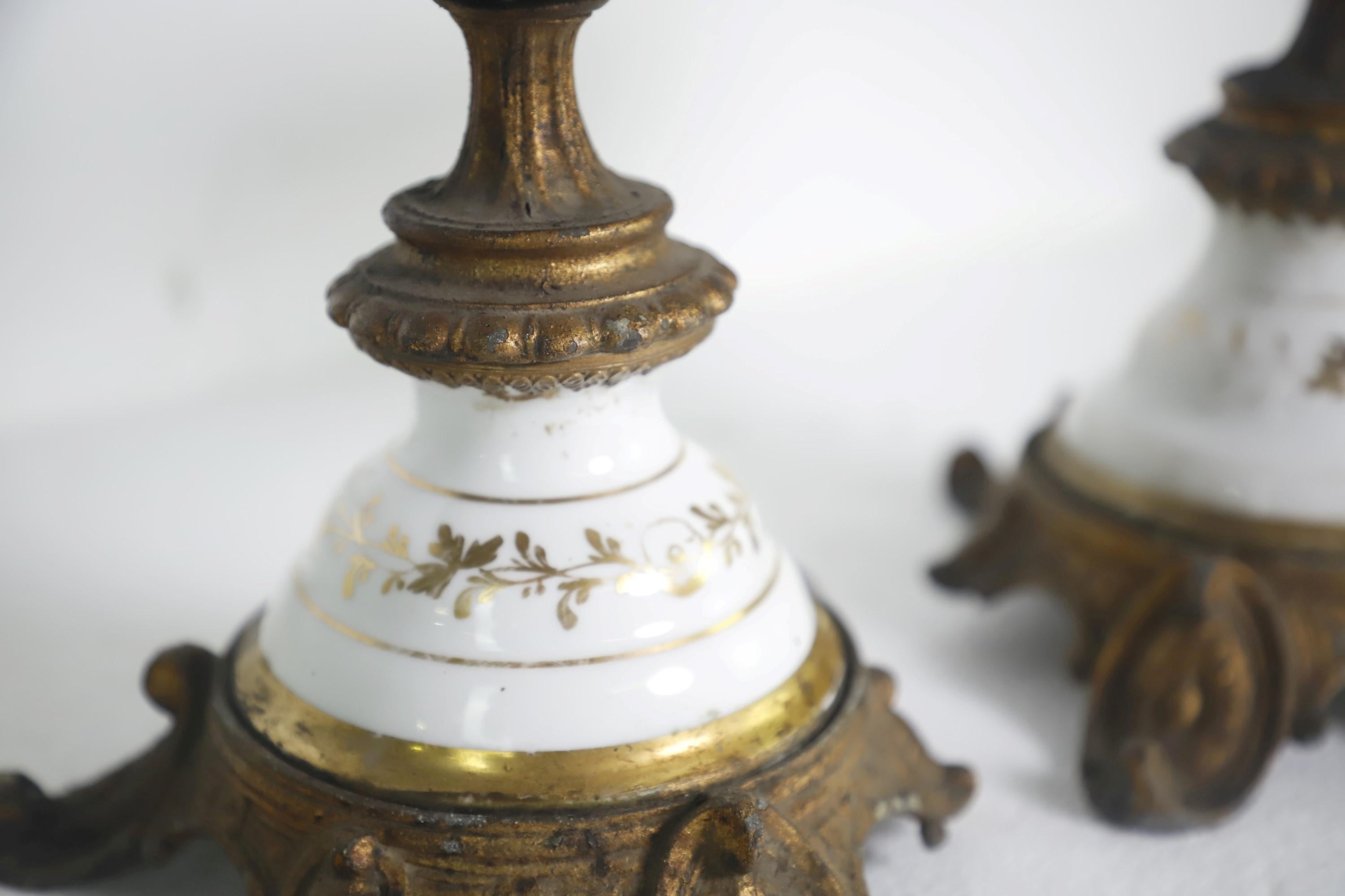 Ornate brass plated spelter zinc metal oil lamp holders with a white and gold porcelain body. They are patinaed but are in good condition. Priced as a pair. Please note, this item is located in our Scranton, PA location.