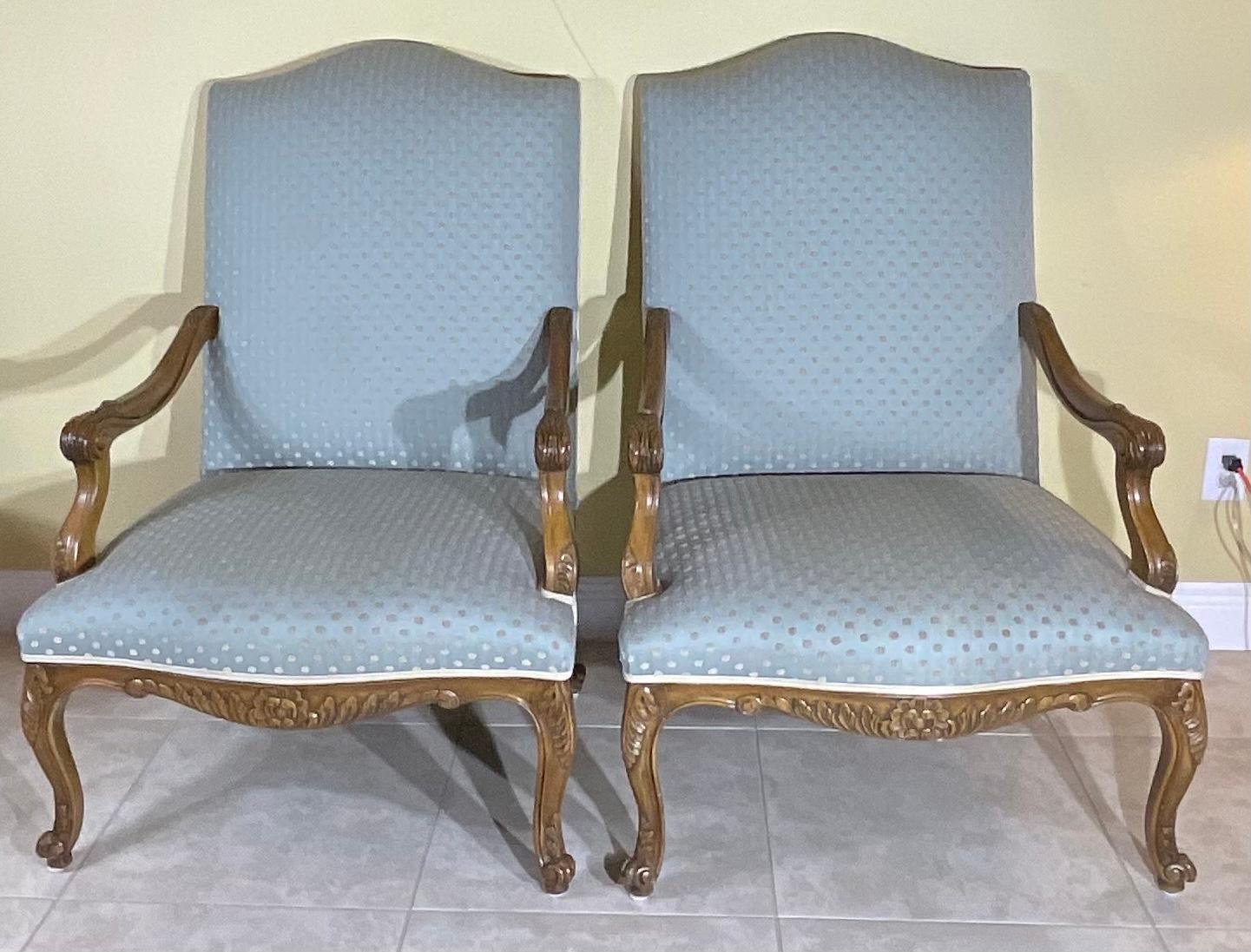 Gorgeous pair of hand carved armchair, quality updated upholstery. Sued like backing and trimming, classic French Style elegance. The chair nicely firm cushioned and comfortable The interior seat measures: 25”wide x 22” deep. Very good vintage